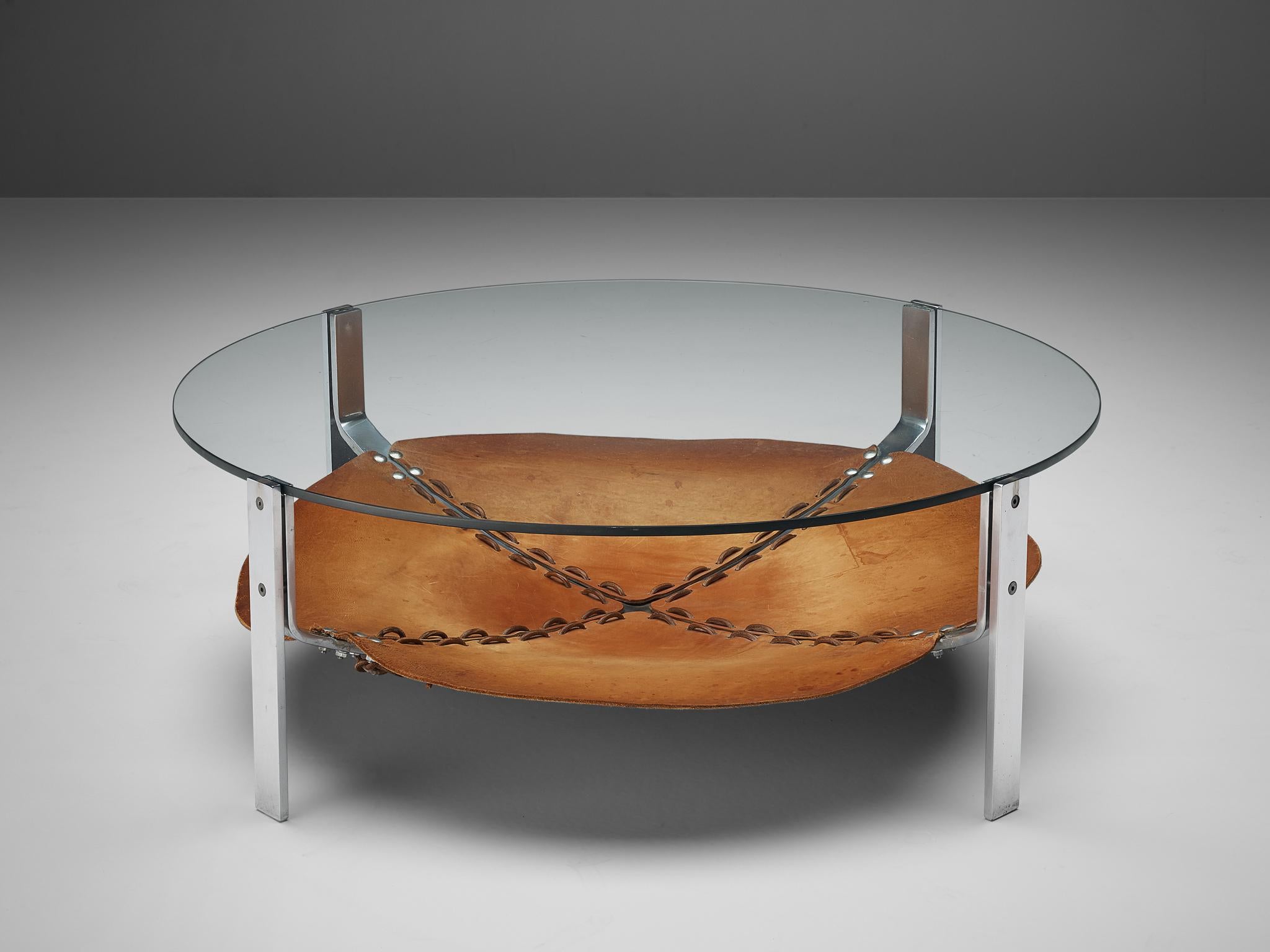 Round coffee table, steel, leather, glass, the Netherlands, 1970s

This round coffee table consist out of a metal structure building the four legs. On the level below the glass tabletop a beautifully patinated cognac leather 'shelve' is created,