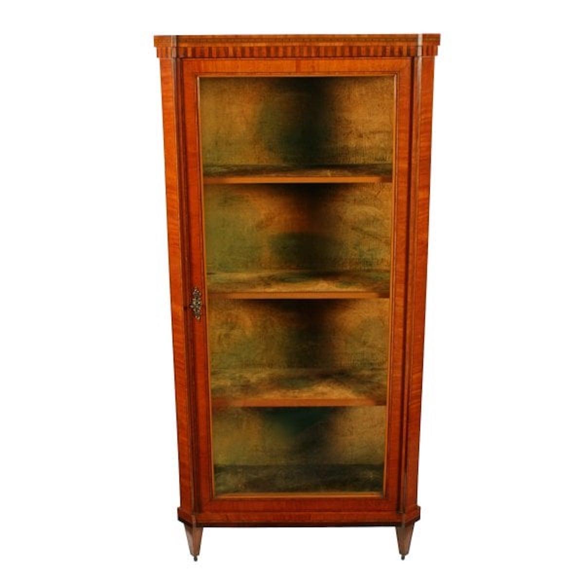 A 19th century Dutch satinwood single door display cabinet.

The cabinet is decorated with inlays and cross banding and has an inlaid dental decoration along the top edge.

The interior has three fixed shelves with satinwood front edges and