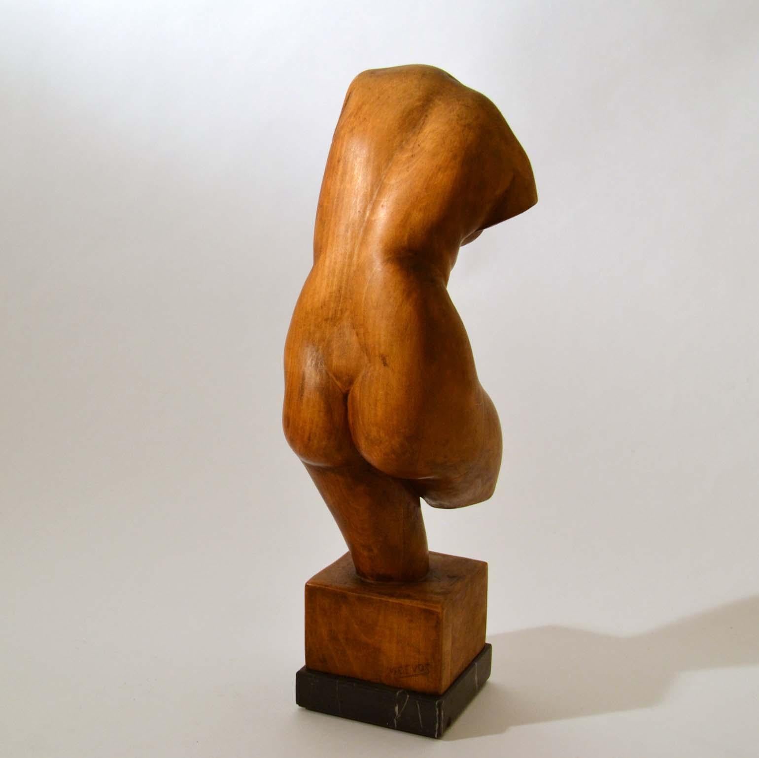 Expressive hand carved sculpture of dynamic female figure by the Dutch artist V. de Vos placed on a black marble base.