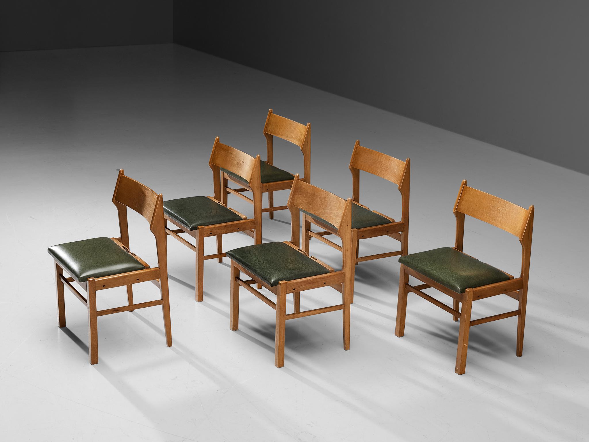 Dining chairs, wood, dark green leatherette, The Netherlands, 1960s. 

Modest set of six dining chairs. Its design shows clear lines and an open backseat. The dark green leatherette seats give a striking contrast with the warm color of the wooden
