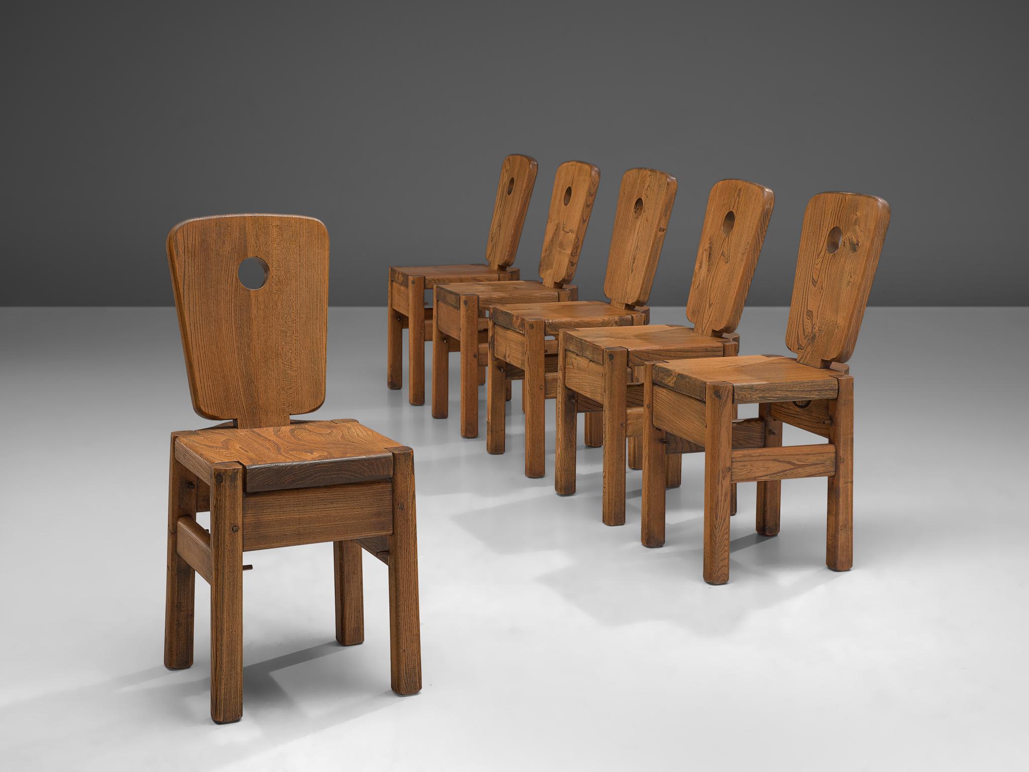 Set of 6 dining chairs, oak, The Netherlands, 1960.

Robust set of chairs are executed in aged, solid oak. The chairs have a very solid and geometric backrest. The chairs are both functional and clear in their design, as is common of most Dutch