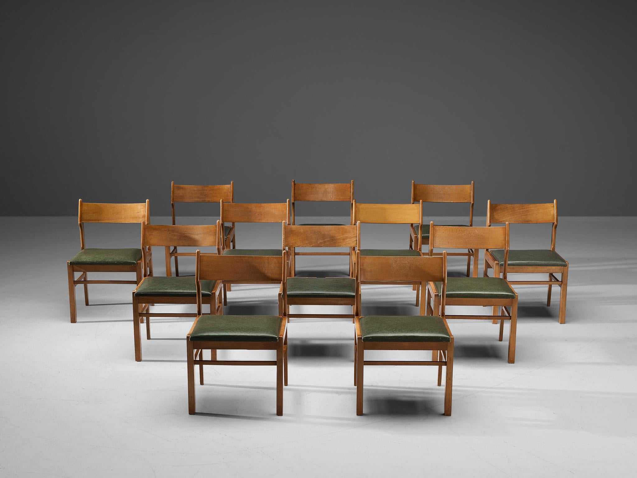 Dining chairs, wood, dark green leatherette, The Netherlands, 1960s. 

Modest set of twelve dining chairs. Its design shows clear lines and an open backseat. The dark green leatherette seats give a striking contrast with the warm color of the wooden