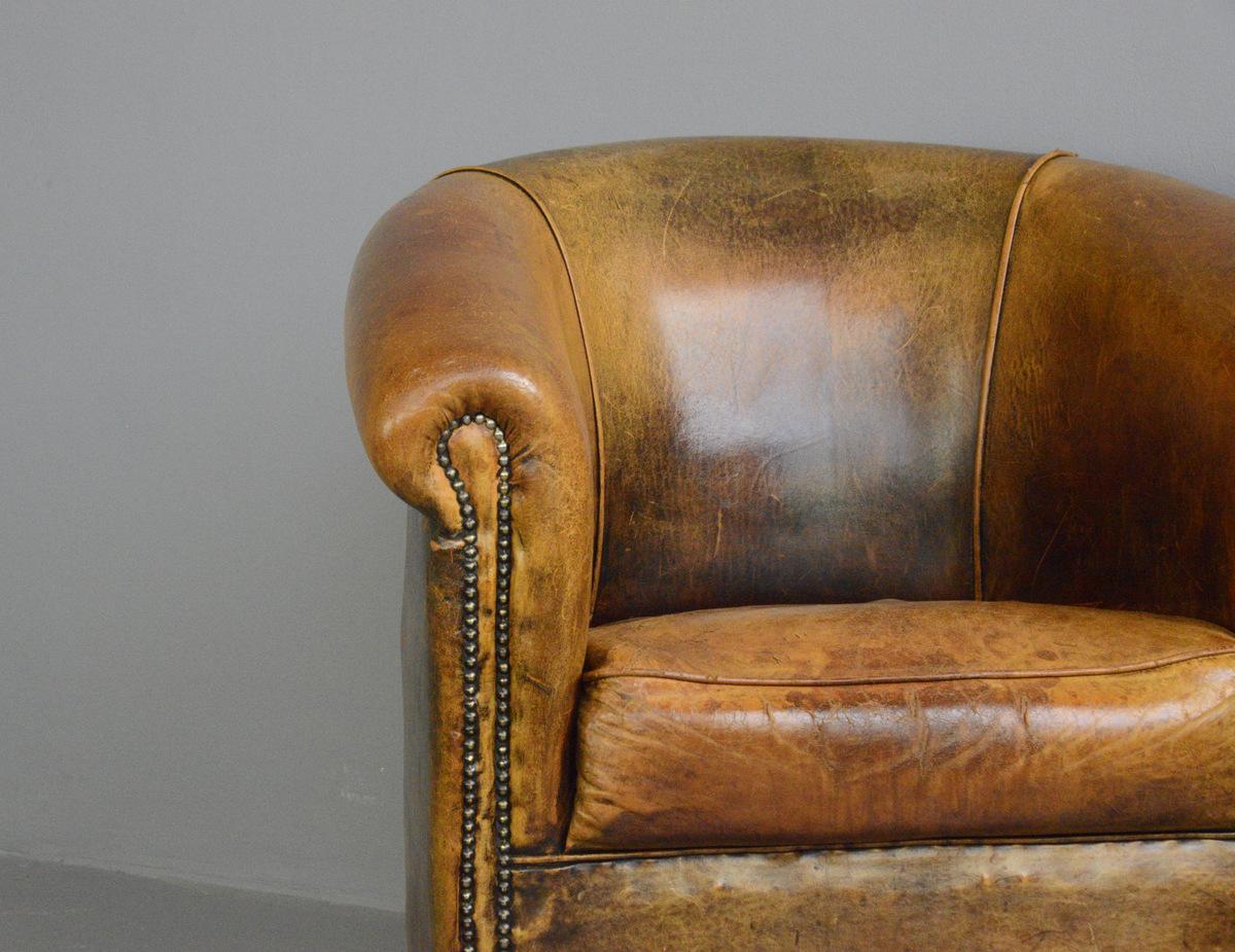 Dutch Sheepskin leather Tub chair

- Brass studs
- Black legs
- Sheepskin leather
- Dutch ~ 1950s
- 87cm wide x 80cm deep x 84cm tall
- 44cm seat height

Condition Report

No major rips or structural damage, the leather on the seat does