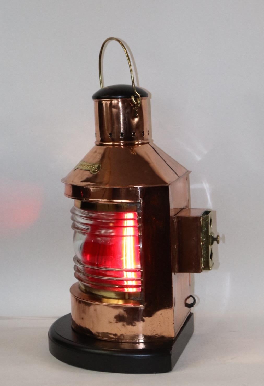 Copper ships lantern with highly polished and lacquered finish. With brass badge marked 