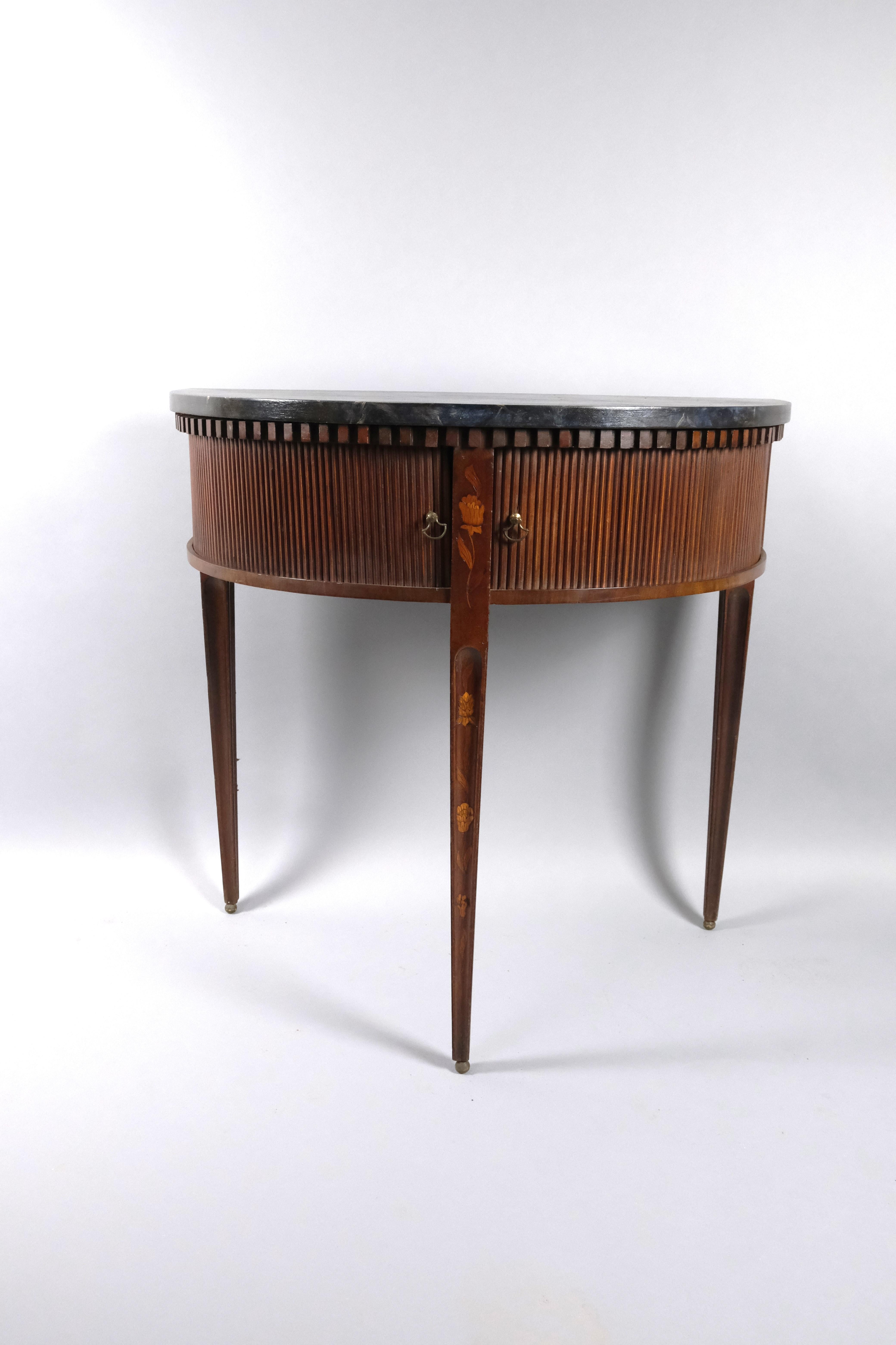 Hutton-Clarke Antiques is delighted to present a refined antique Dutch mahogany side table from around 1800. This elegant piece stands gracefully on tapered legs, meticulously adorned with inlays, providing a touch of sophistication to its design.
