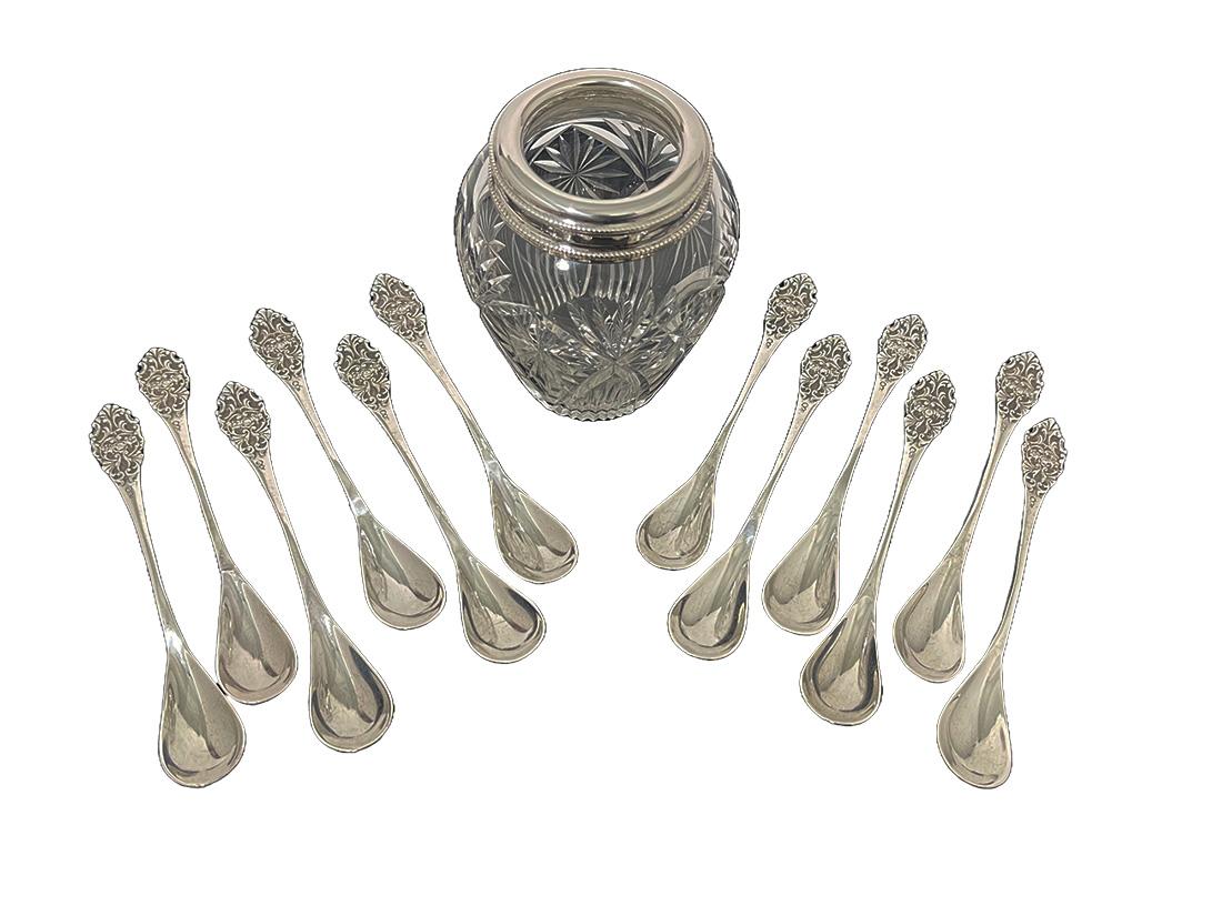Dutch silver and crystal spoon vase with twelve spoons, 1910

Silver and crystal spoon vase with pearl pattern rims and the crystal is facet cut crystal with star pattern. The silver rim of the spoon vase the silver purity is 835/1000 (also the