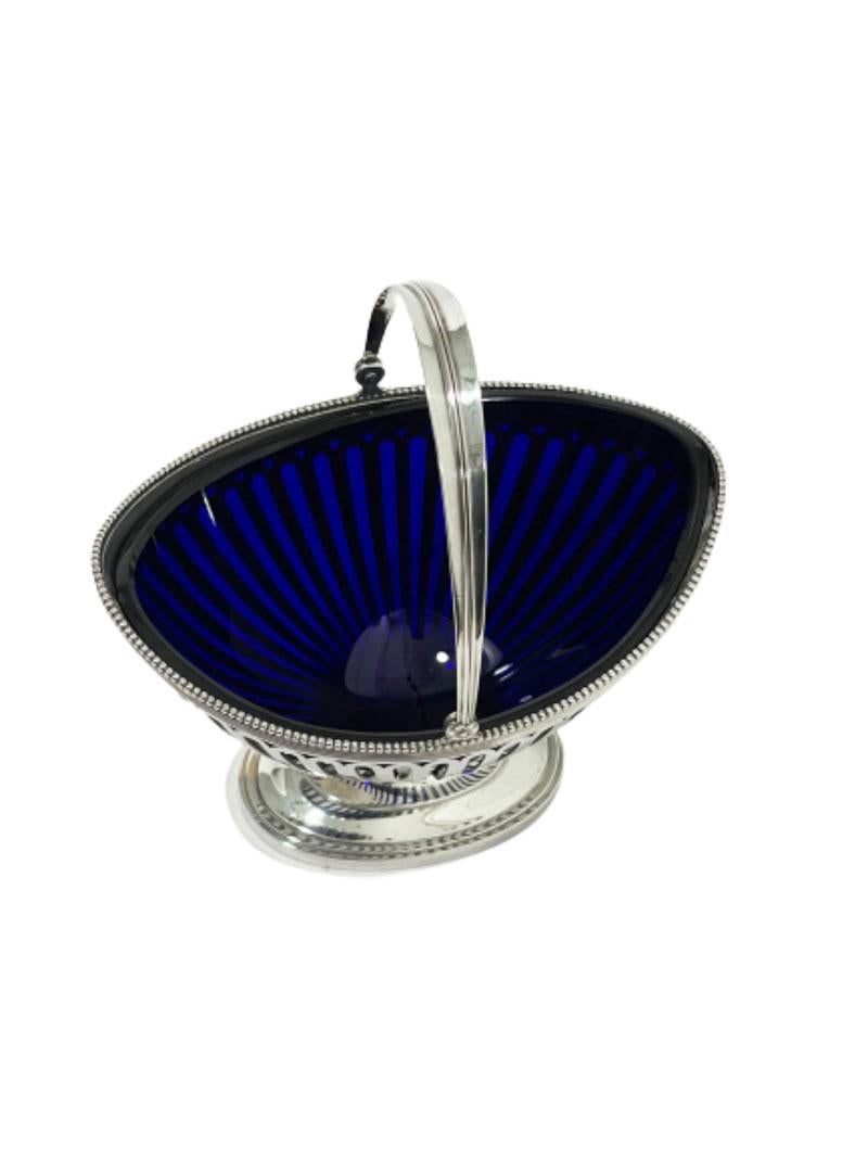 Dutch silver basket with blue glass in Empire style, 1915

Dutch Silver basket in Empire style with pearl rim with 835/1000 silver purity and movable handle and blue oval round shaped glass.
Hall marked by silversmith A. Bonebakker & Zn. Silver