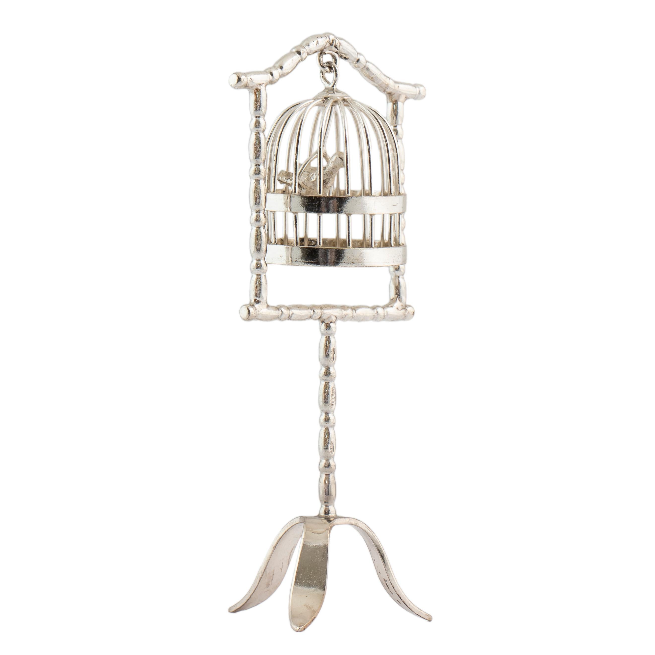 Beautiful Dutch silver miniature with moving parts, a suspended bird cage enclosing bird on tripod pedestal stand-3 ½ in. ( 8.9 cm) high; 5/8 in. (1.6 cm) cage diam. 

Stamped with London import marks date letter cursive small t for 1974, and Dutch