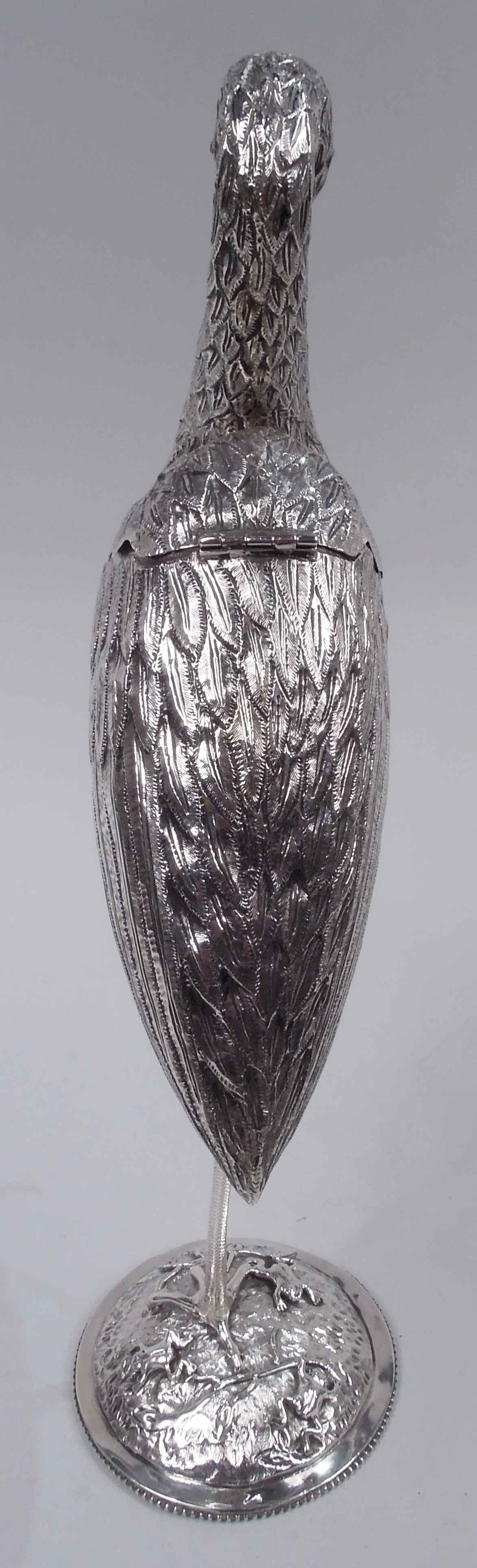 Dutch silver figural spice box. Imported to England in 1891 by BH Joseph & Co. An egret gracefully scrolled neck, red glass eyes, and gaping beak stands on one scaly leg, the other leg raised with clenched talons. A beautiful bird with nicely