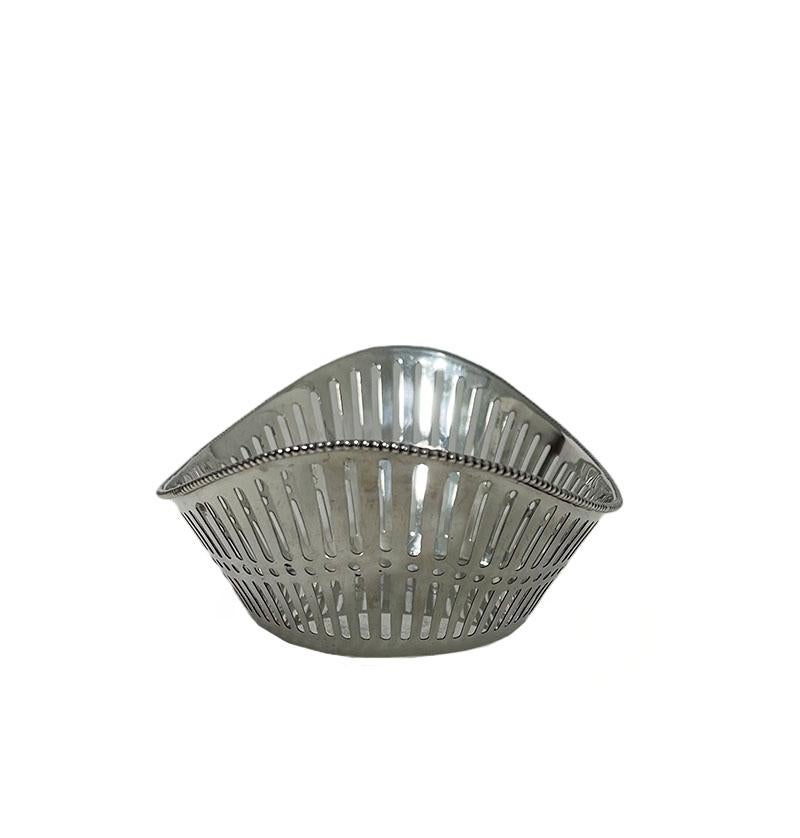 Dutch silver bonbon basket by Schriek & Looren de Jong, 1948.

A Dutch oval silver bonbon basket with openwork silver and pearl edge, made by H. Schriek & H. Looren de Jong ( worked during 1943- 1967). The bonbon basket is marked with the silver