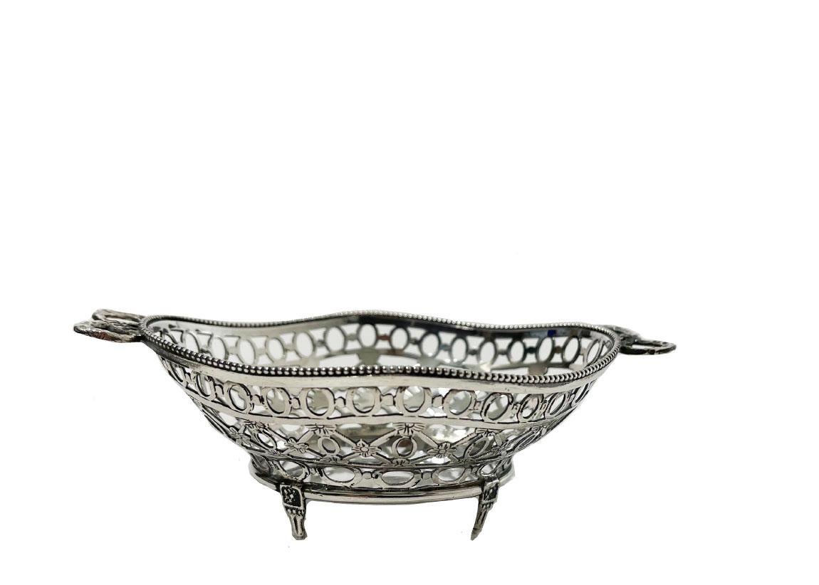 Dutch silver Bonbon basket with bow handles, 1904 

A Dutch silver bonbon basket. openwork basket cut out by hand in oval shape, scalloped with pearl rim and bow handles, raised on 4 feet. 
Hallmarked with Dutch silver. Re-marked in 1904 with the