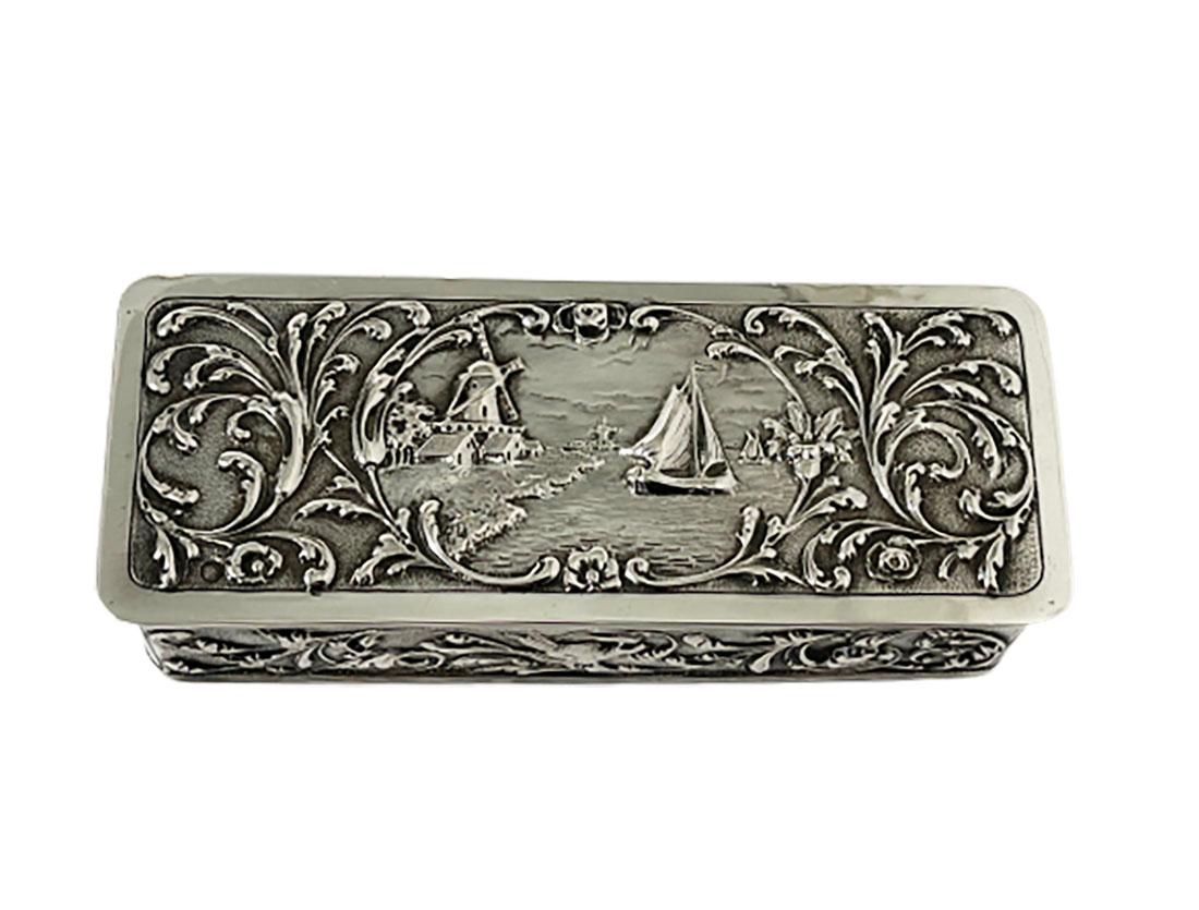 Dutch Silver box by Zaanse Zilversmederij, 1916

A Dutch silver box 835/1000 purity of silver, completely Dutch silver hallmarked. With lion, master's mark and year letter. Master mark of the Zaanse Zilversmederij, worked during 1916-1920,