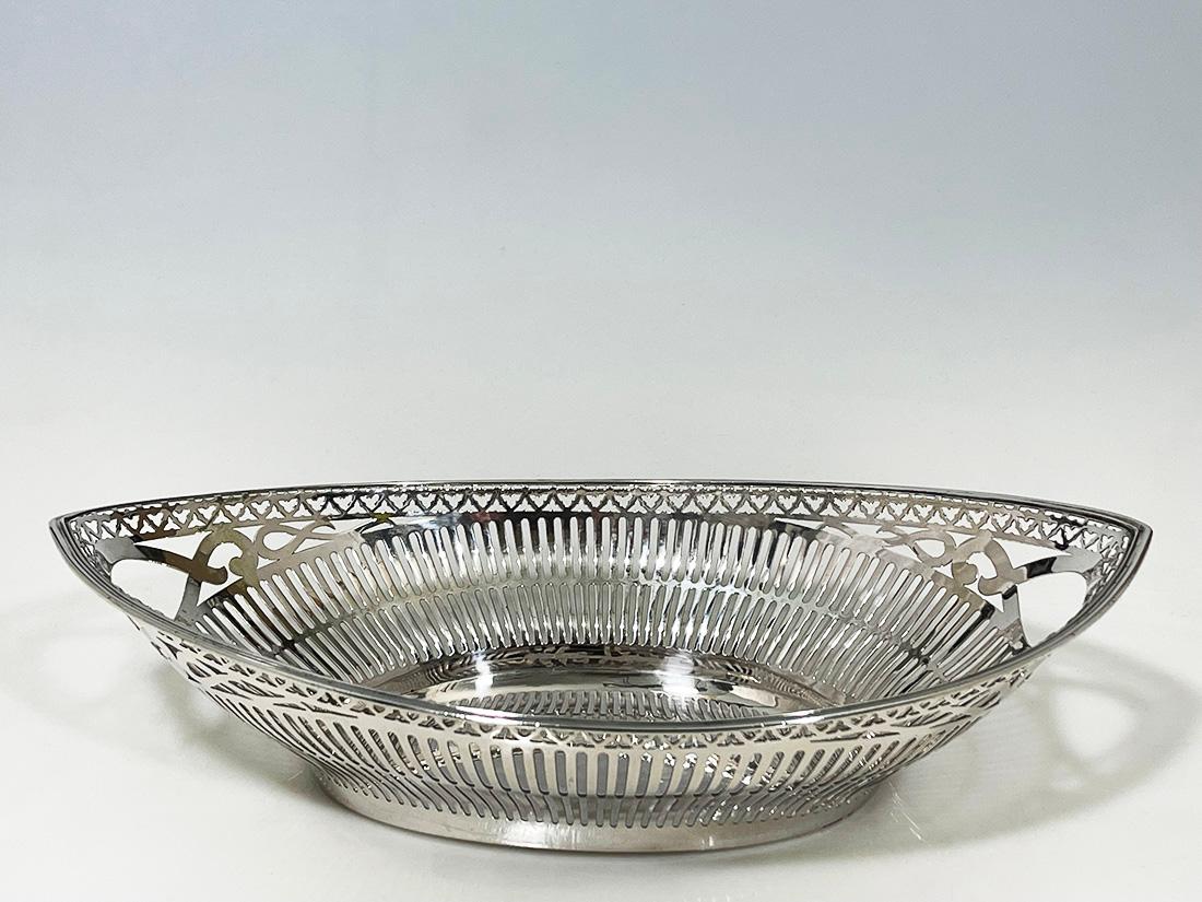 Dutch silver bread basket by Pressburg and Son, Haarlem, 1956

An oval silver bread basket with cut-out vertical lines and graceful handles
The basket is Dutch silver hallmarked with the silversmith hallmark of Pressburg and Son, Haarlem this mark