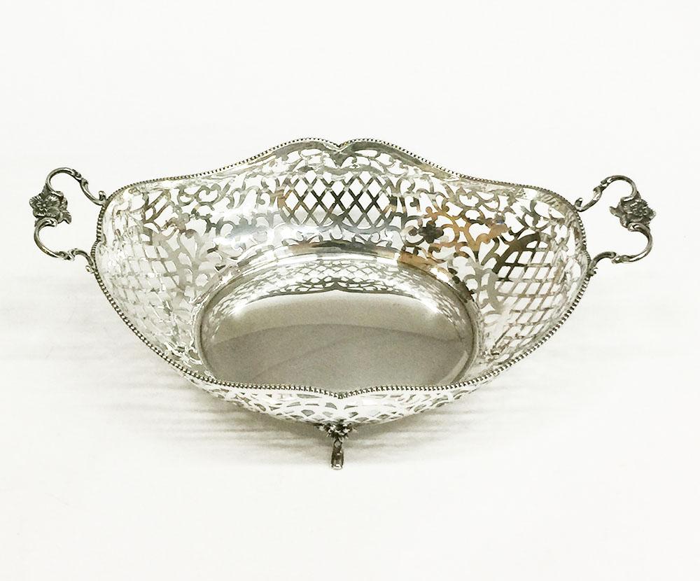 Dutch silver bread basket, J. Krins, Schoonhoven, 1967

Dutch silver bread basket
The basket is decorated oval in the style of Louis XV with a pearl border and floral handles. 

The silversmith is J. Krins, Schoonhoven dated with the year