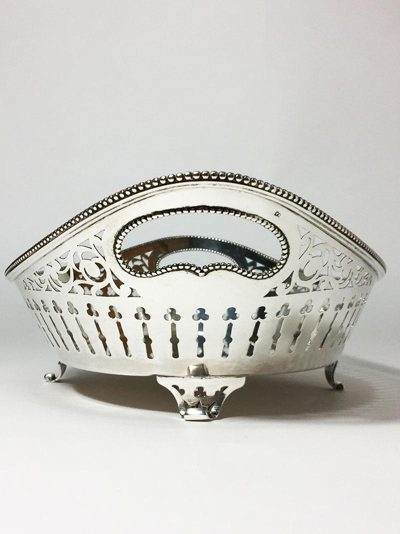 Dutch Silver Bread Basket, N.M. van Kempen en Zonen, 1894

An oval Dutch very large silver bread basket openwork sawn with pearl rim with handles

The silversmith is Fa. N.M. van Kempen en Zonen
Silver purity is 925/1000

Fully marked with