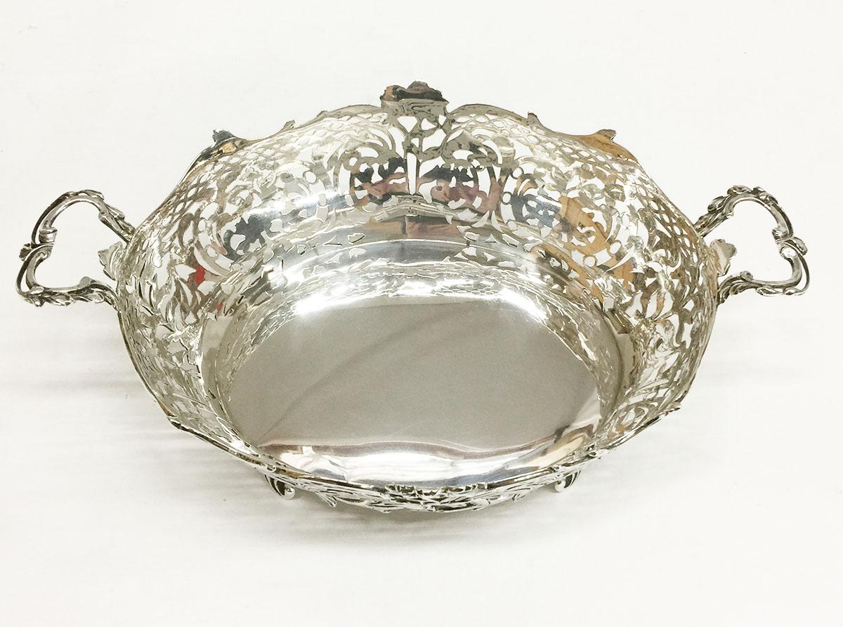 Dutch silver bread basket, Zaans Zilversmederij, 1925

An oval Dutch silver bread basket with handles and richly engraved and openwork floral decor. 
The silversmith is Zaans Zilversmederij, Amsterdam, dated with the year letter P from the year