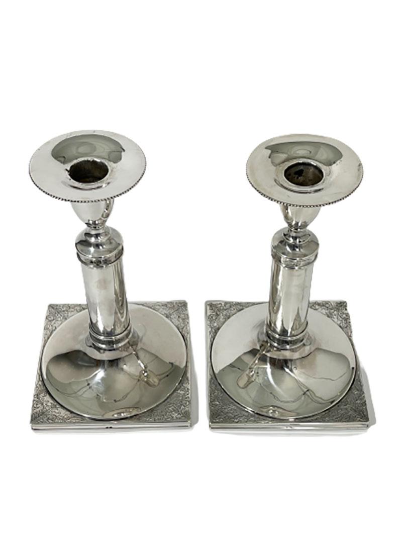 Dutch silver candleholders, mid-20th century.

A set of candleholders Dutch silver hallmarked with the Master sign of Molenbeecker NV / bv In den Silveren / Mannetje, C.C. 't (dir) (The Haque 1953 -). 
Silver purity is 925

2 candlesticks on a