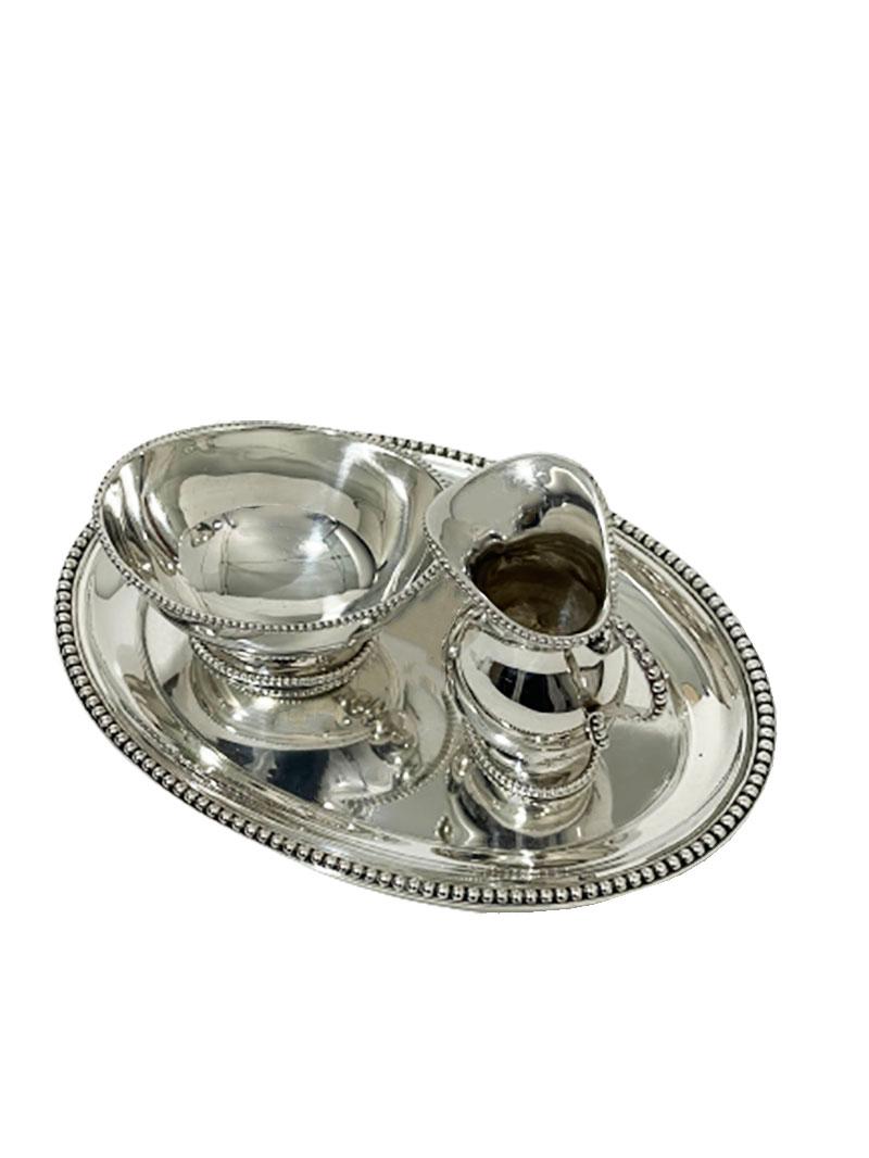 Dutch silver cream set by D.J. Aubert, Aubert & Zn.

A Dutch silver cream set, exists of 3 pieces
An oval small serving tray wit a small jug for cream and a small bowl for the sugar.
The silver is smooth with pearl edges.
Silver Dutch hall