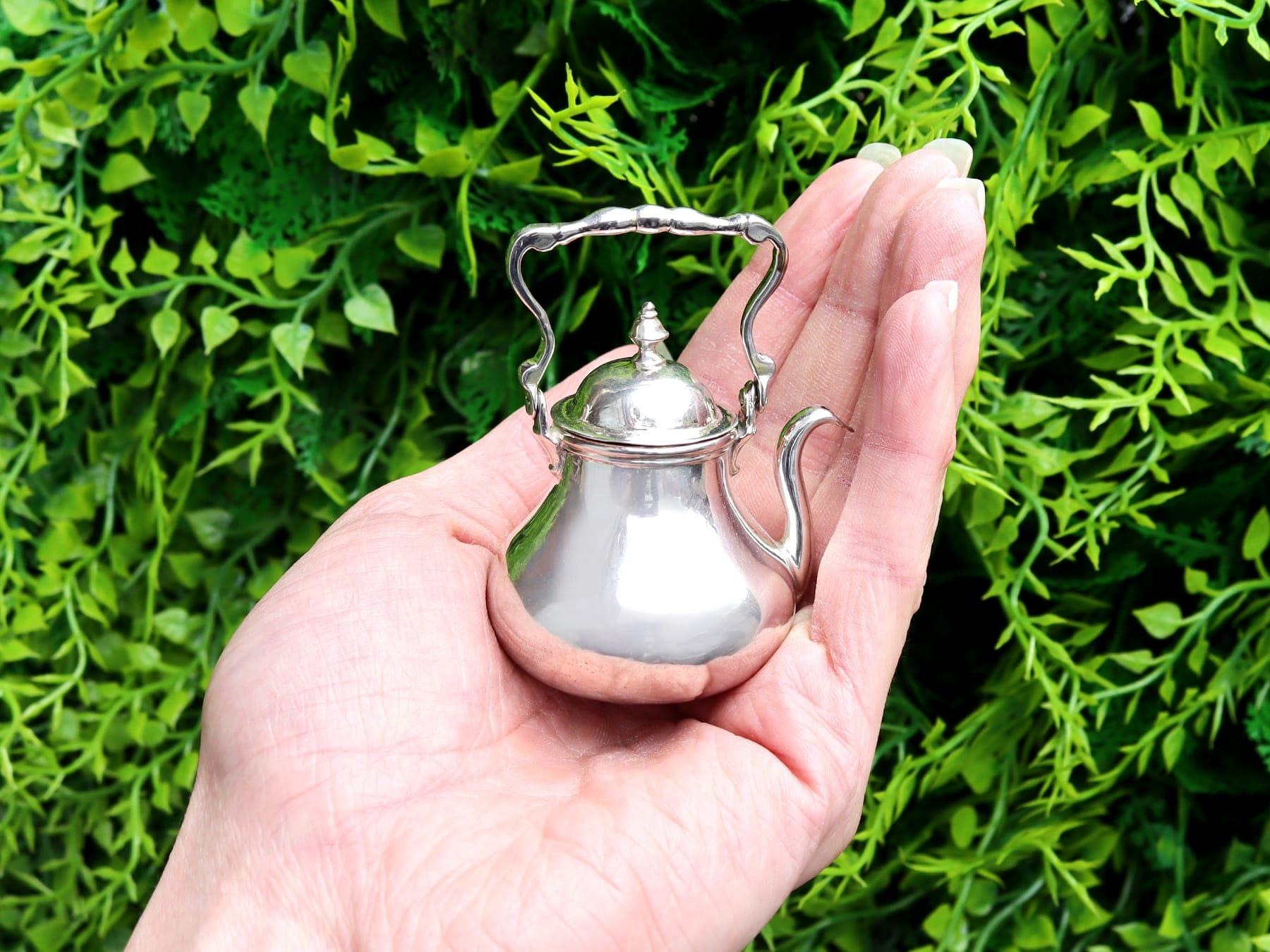 This exceptional, fine and impressive antique 18th century Dutch silver miniature tea kettle has a circular baluster shaped form.

The body of this silver kettle is plain and unembellished, with an applied border to the upper rim.

This antique