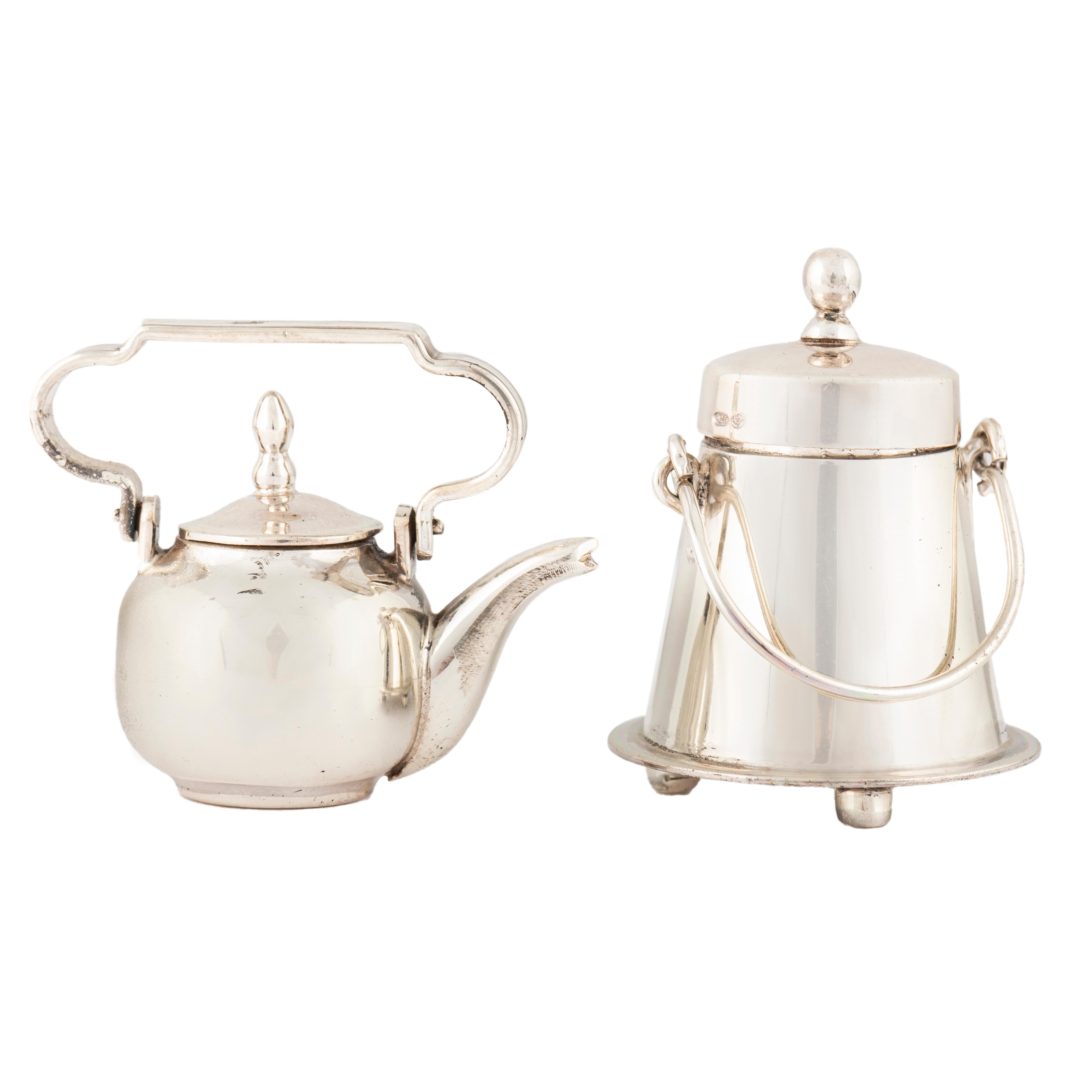 Dutch Silver Miniatures for a Doll's House, H. Hooykass, Schoonhoven, 1970s
 
Two beautiful Dutch silver miniatures comprising a milkchurn on three bun feet and a bulbous teapot, each with a slip-on cover and swing handle (2) 

Stamped HH for H.