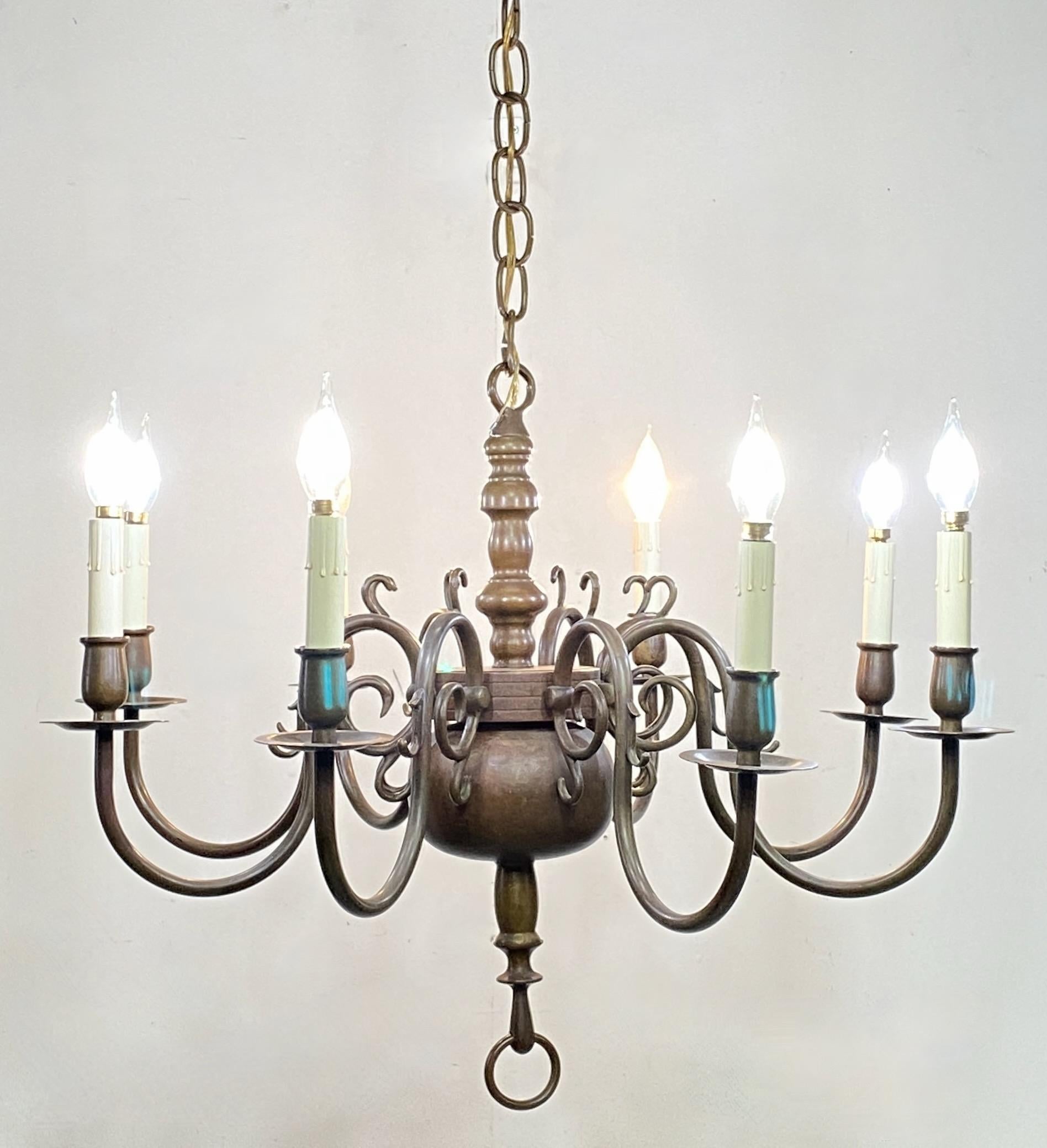 An early to mid 20th century Dutch or Flemish style bronze eight arm light fixture. Very accurate and high quality in excellent condition. Completely original, recently reconditioned. 
Chain can be shortened to suit the buyers needs at no extra