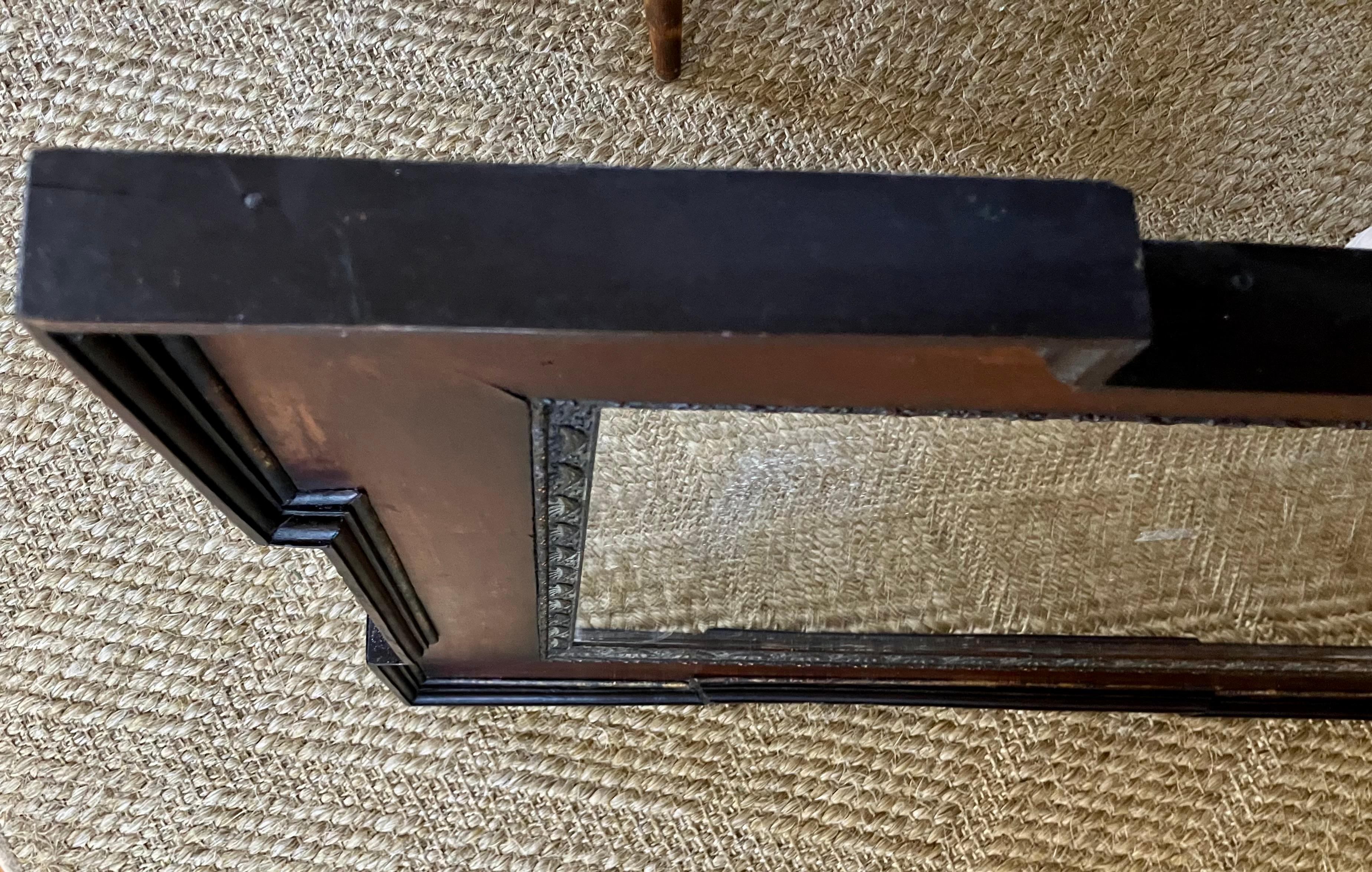Dutch Style Mirror.  Antique Flemish style mirror in mahogany with ebonized corner block trim and gilt inner end outer borders with swag detailing and original mercury glass plate; with original label from Rome. Italy, late 19th century

Dimensions:
