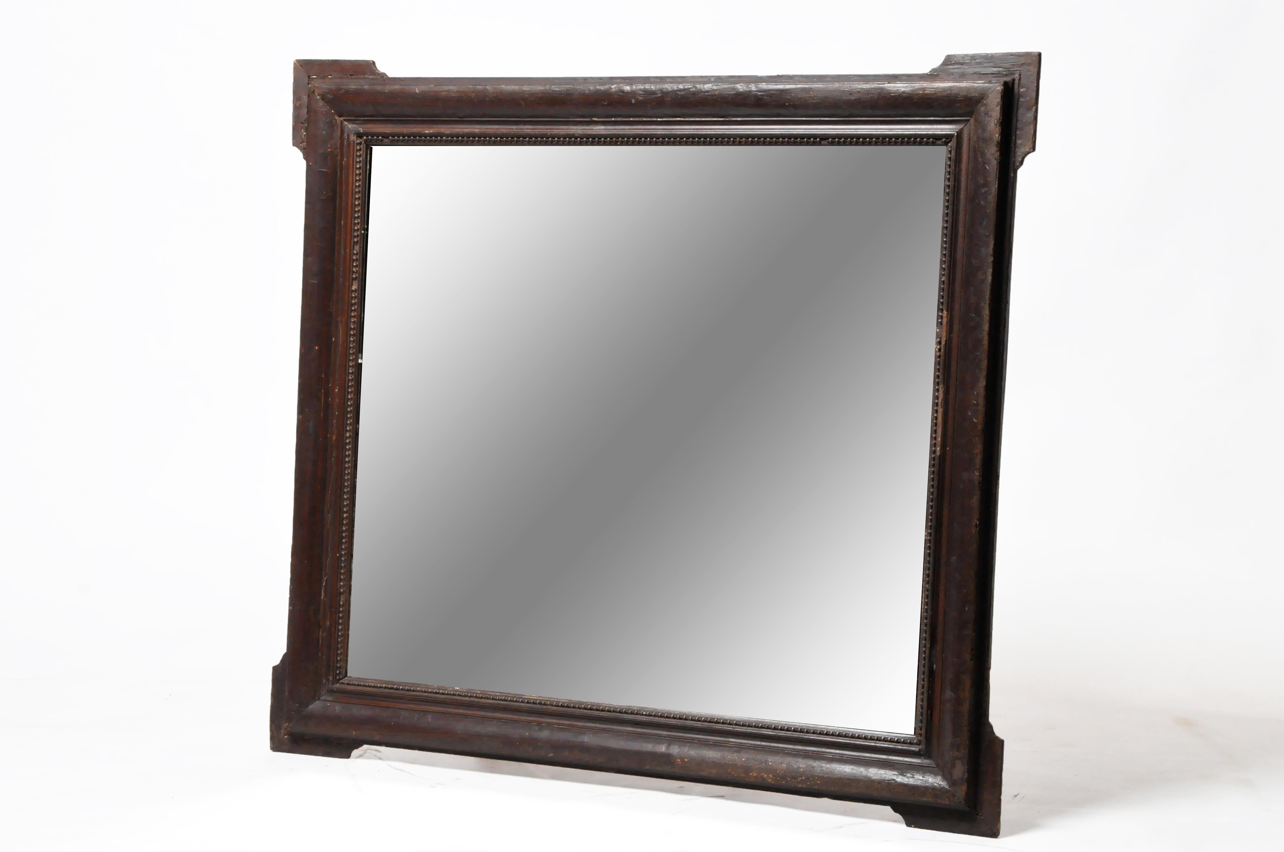 This unusually simple, heavy wooden frame was made in France according to the Dutch style. Dutch (or Flemish) design reached a peak in the 17th Century and favored simple shapes and the color black. This is partly due to the primacy of protestant