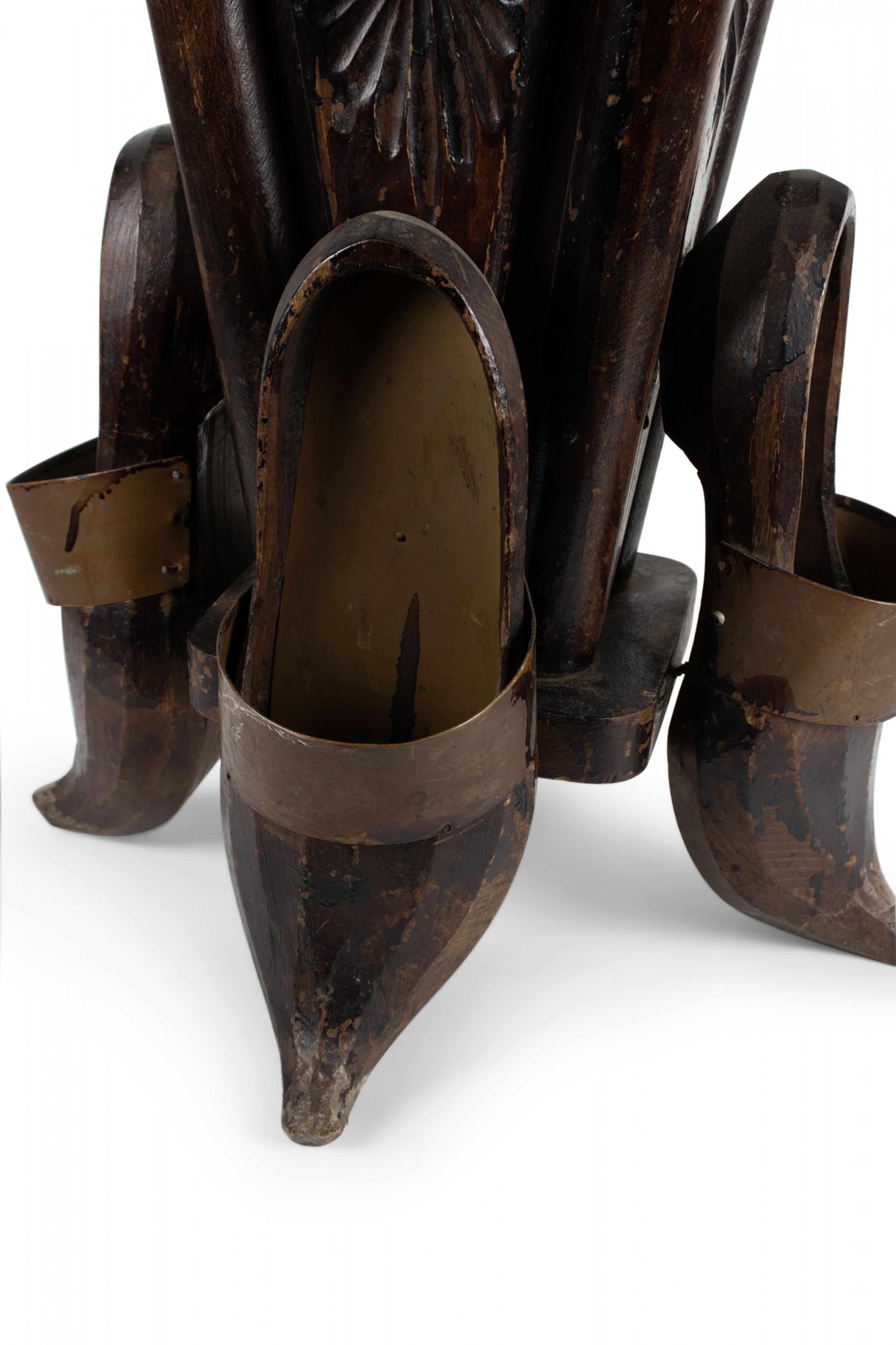 Continental Dutch-style (19/20th Century) carved and stained wood umbrella stand with 4 shoes at base and copper trim