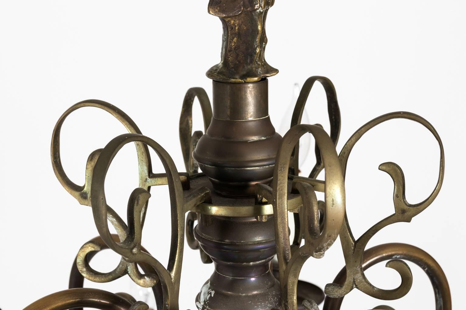 Dutch brass two-tier chandelier with twelve-lights that also feature a baluster and ball stem with scrolled arms, circa late 19th century.
       