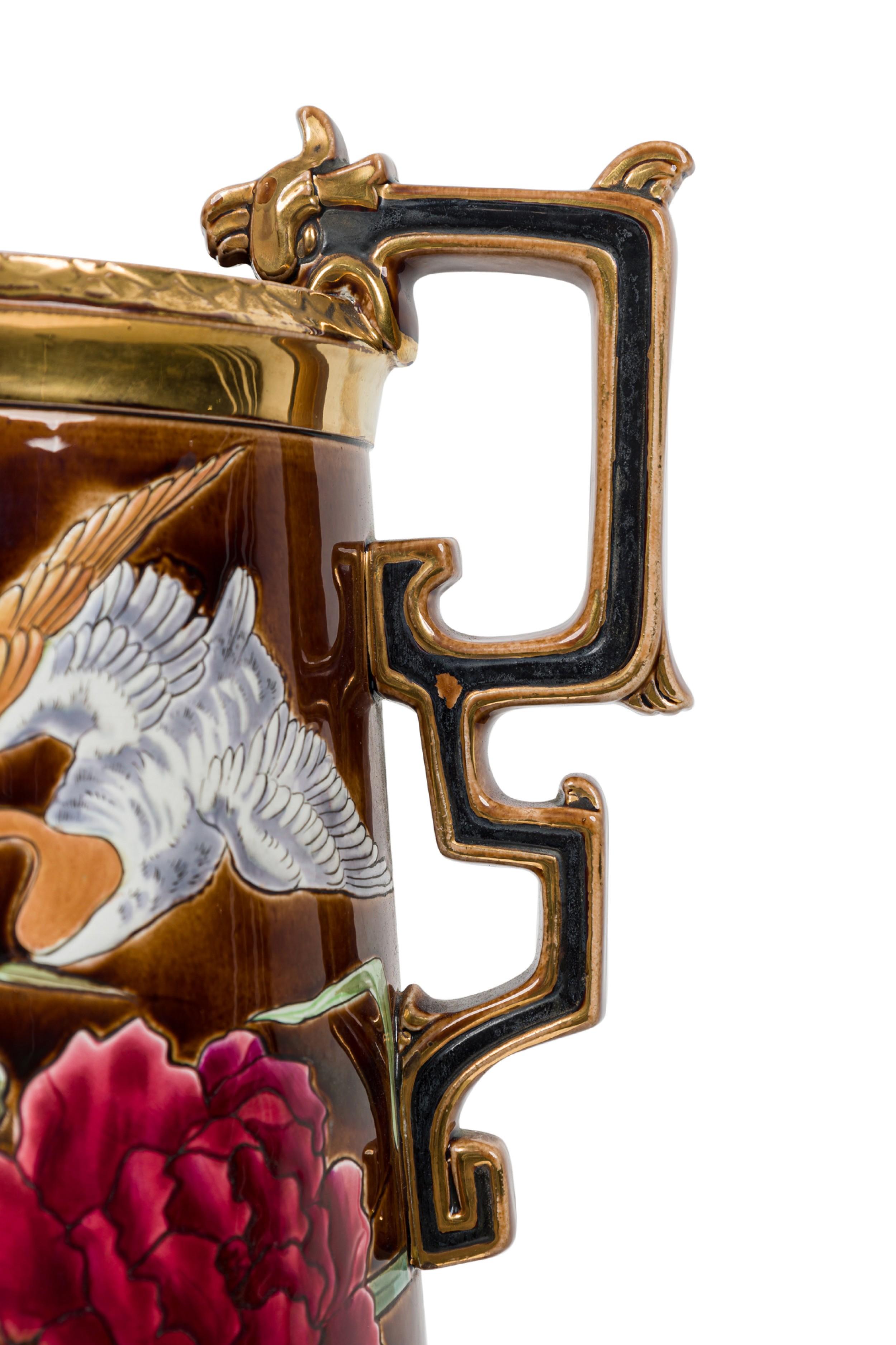 Niederländische viktorianische (19. Jh.) Monumentalvase aus Keramik in eiförmiger Fußform mit verschnörkelten Henkeln, die eine Naturszene in flachem Relief zeigt: eine Ente, die über einer üppigen Flora schwebt, gemalt in kräftigen Farben auf