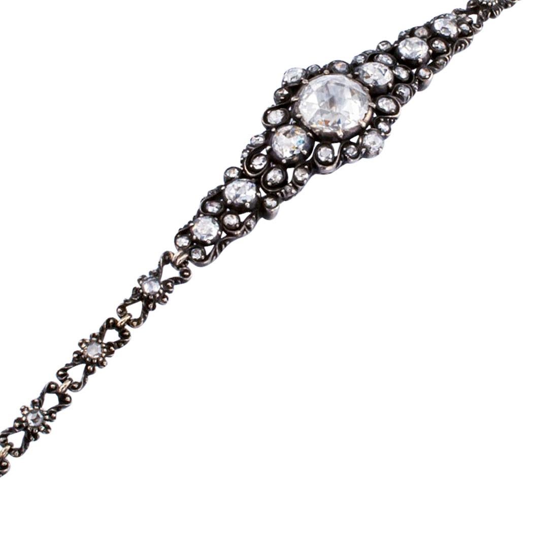 Late Victorian Dutch rose-cut diamond gold and silver bracelet circa 1900. The articulated  design centers upon a large, round rose-cut diamond weighing approximately 1.75 to 2.00 carats, within an open-work frame set with smaller, similarly-cut
