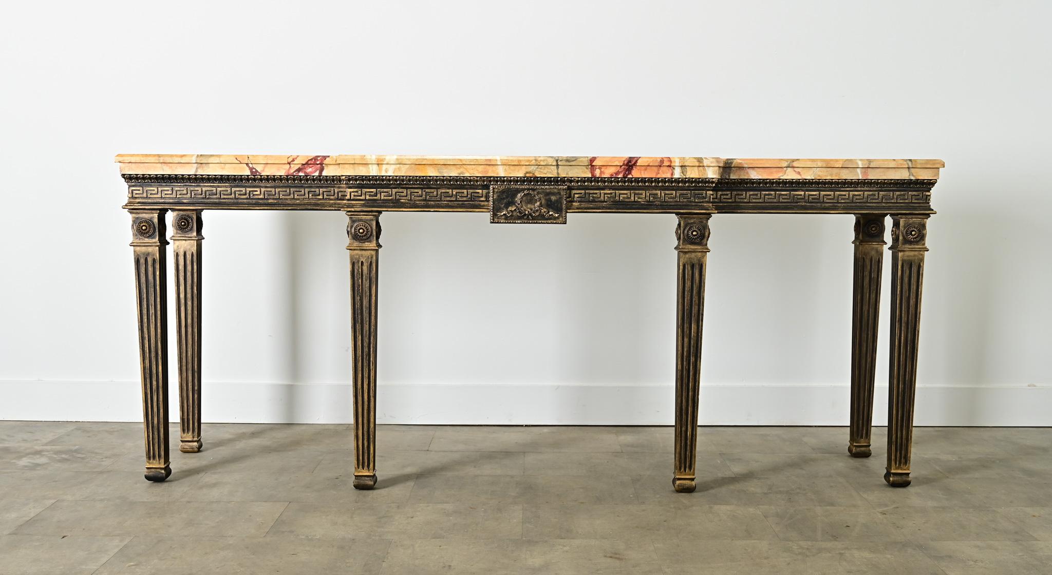 An absolutely stunning vintage breakfront console table in the Louis XVI taste, handpainted in the Netherlands by artisans at the House of Bendhor Le Fay. The top of the table is brought to life with a faux Breche d’Alep marble surface, rendered