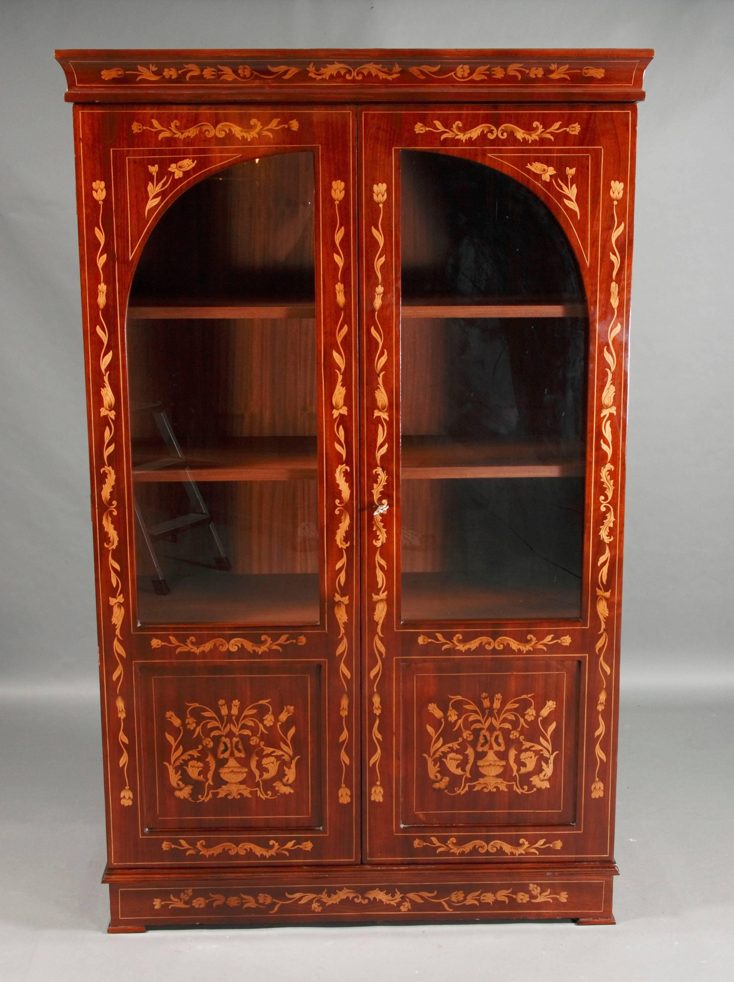 Light mahogany on solid wood.
Exceptionally rich intarsia work.
 2 doors with glass.