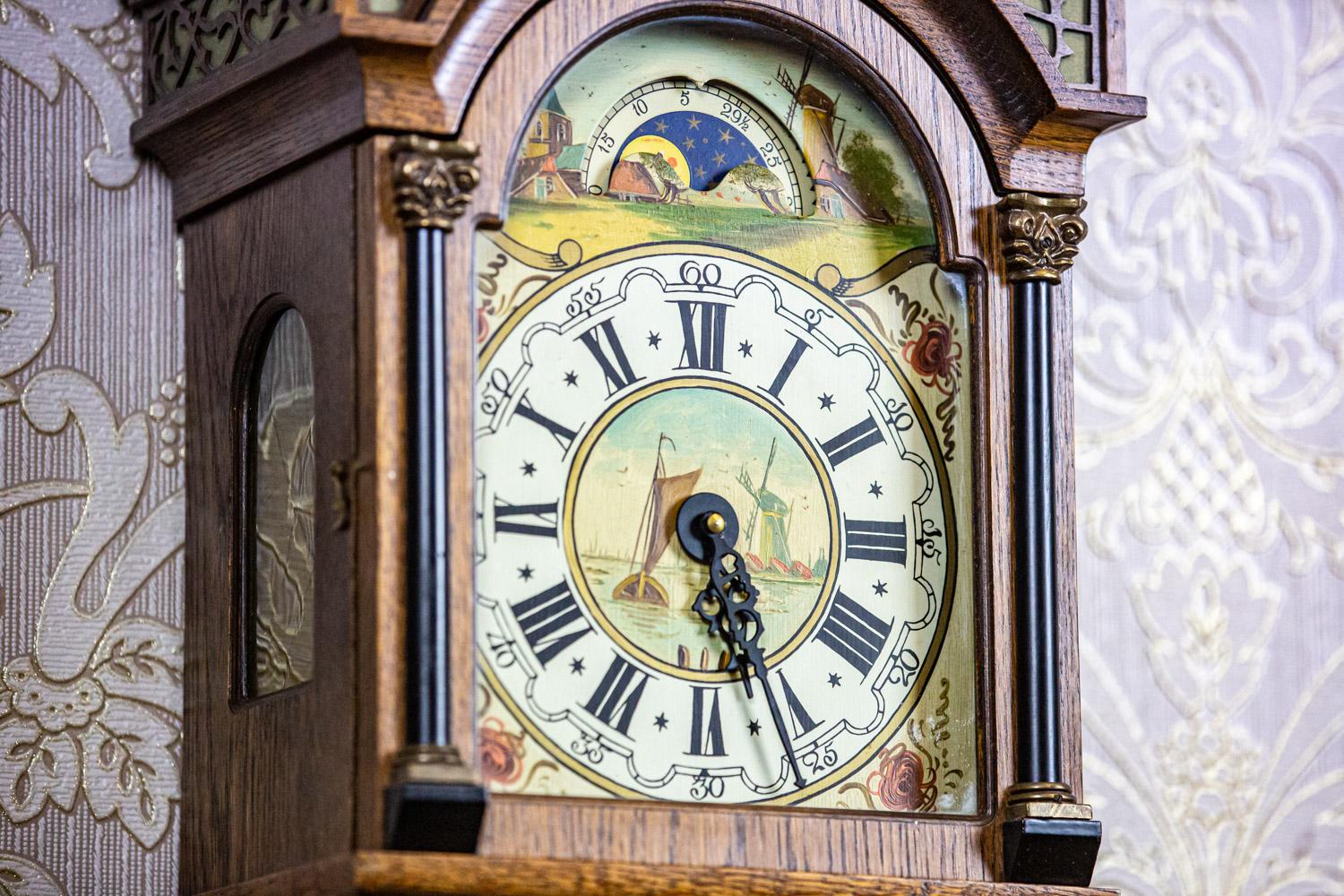 Dutch Wall Clock Stylized as Staart From the Early 20th Century in Oak Case

Wall clock in an oak case with a painted dial, dated before 1939, modeled after 19th-century Staart clocks. Circular ring with hour markings against a painted landscape