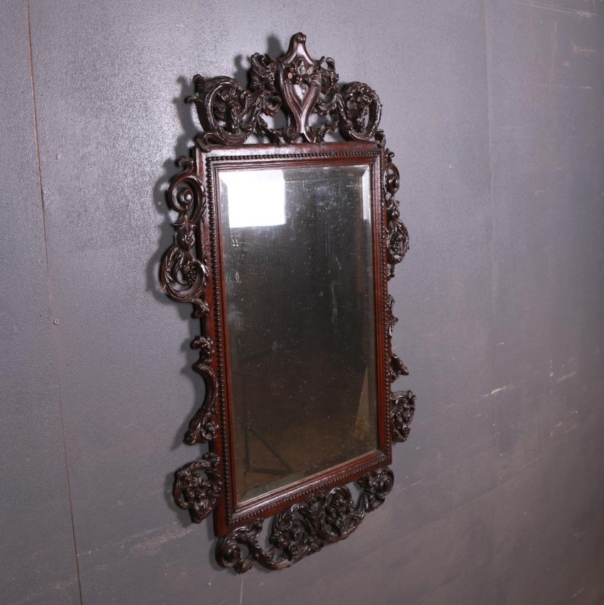 Small 18th century carved oak wall mirror, 1780.

Dimensions
26.5 inches (67 cms) wide
1 inches (3 cms) deep
41 inches (104 cms) high.