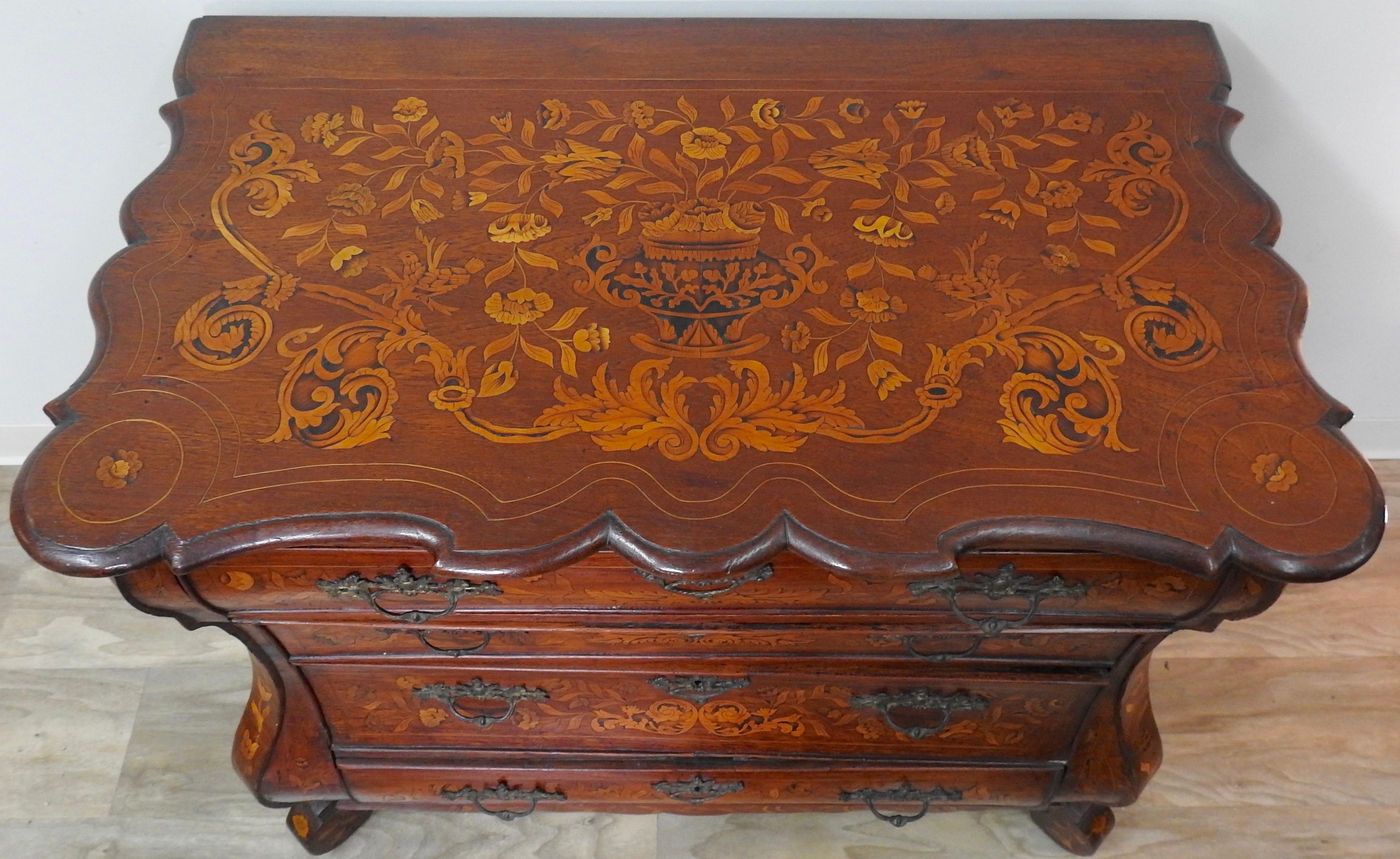 Mid-18th century Dutch walnut bombe' front commode. Beautiful inlay work on this gorgeous piece is Impeccable!!! The chest has a unique base that is reminiscent of a bracket foot but they turned it. The serpentine front is unusual as well by having