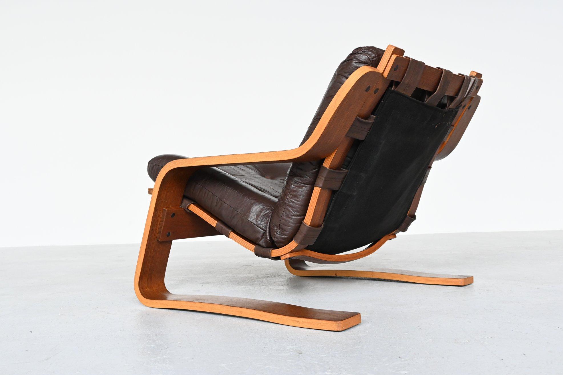 Superb shaped plywood lounge chair, the Netherlands 1970. This fantastic but unknown design is a combination of designs by Ingmar Relling from Norway because of the wood, leather and canvas and Alvar Aalto from the Netherlands who often used bent