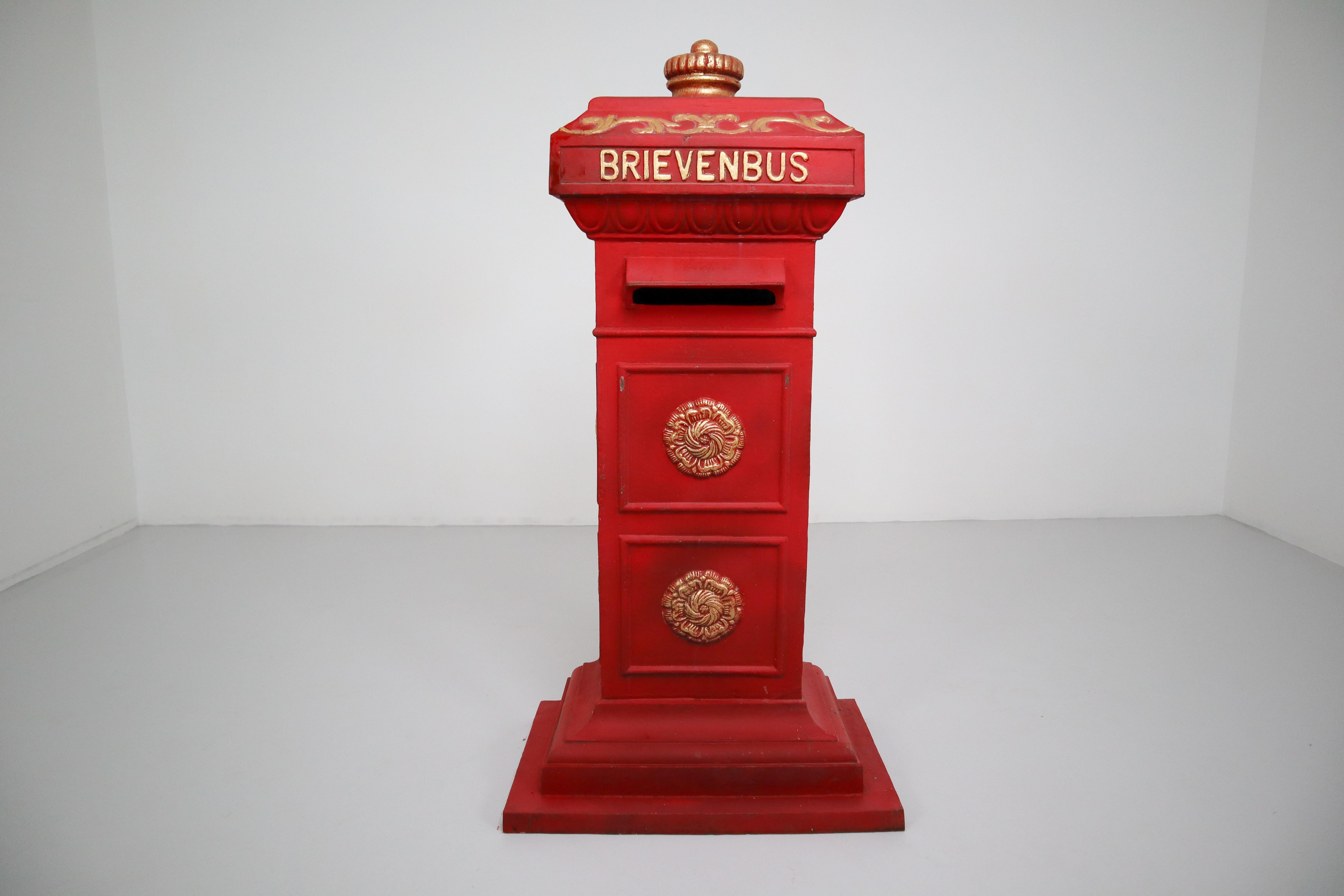 Duth iron mailbox in red and gold paint, the Netherlands, 20th century.