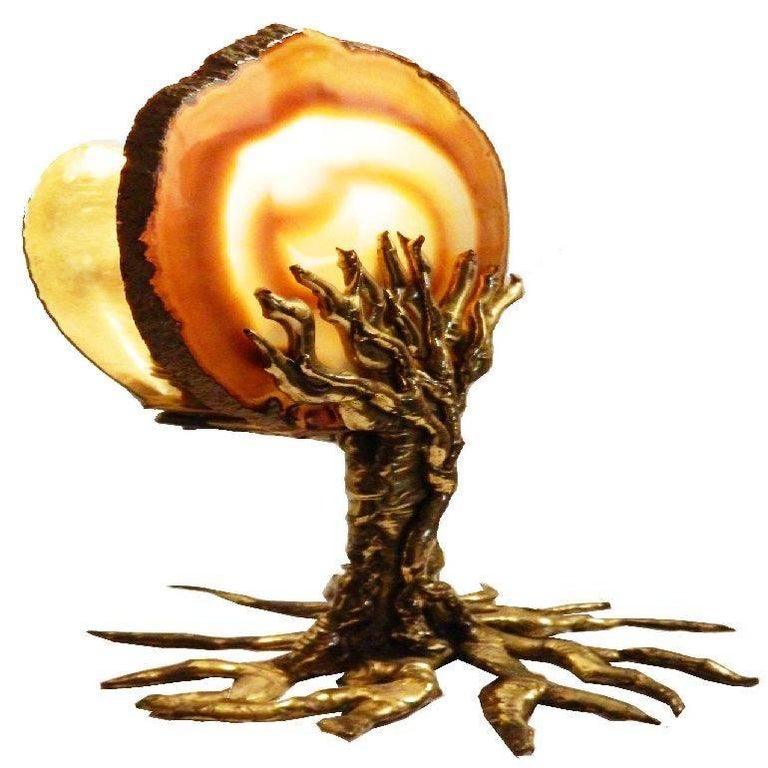 Superb table lamp by Jacques Duval Brasseur, figuring a bronze tree holding a Agate disc Light come through the Agate one light, 25 watt max US rewire and in working condition.