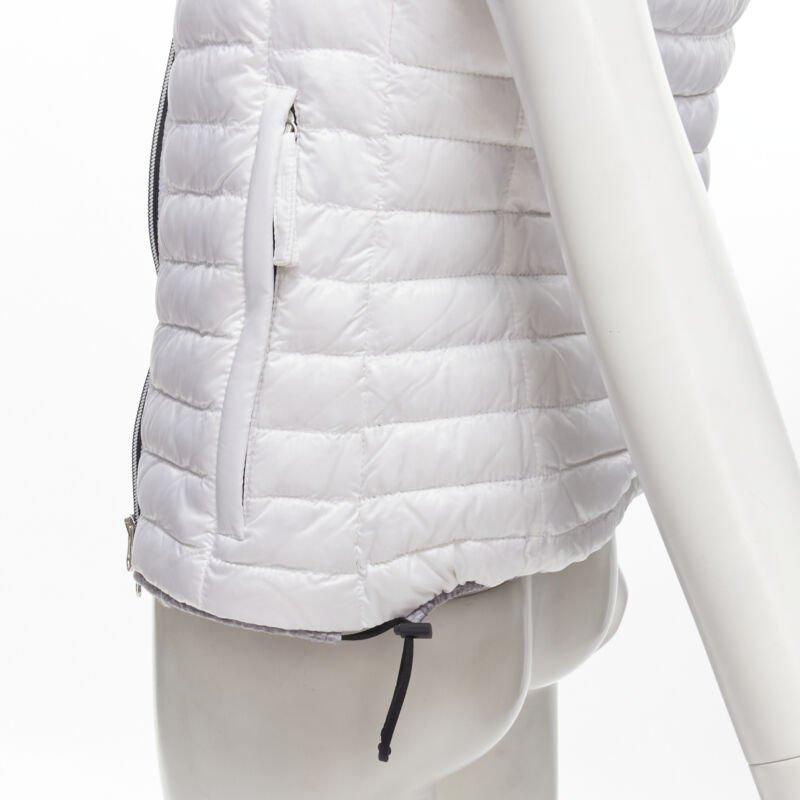 DUVETICA white pure goose new down padded zip hoodie puffer vest jacket IT38 XS
Reference: LNKO/A02039
Brand: Duvetica
Material: Goose Down
Color: White
Pattern: Solid
Closure: Zip
Lining:  Fabric
Extra Details: Elastics and stopper detail at sides