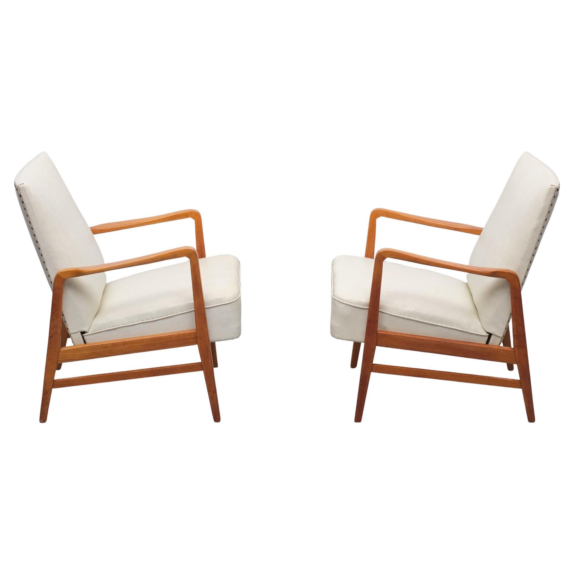 Two early versions of Dux armchairs, Creme color Faux Leather upholstery.
beechwood frame. Rare model. Good sitting comfort. Signed with a Aluminum
plate. Still in a good condition. normal wear and tear. All original condition.