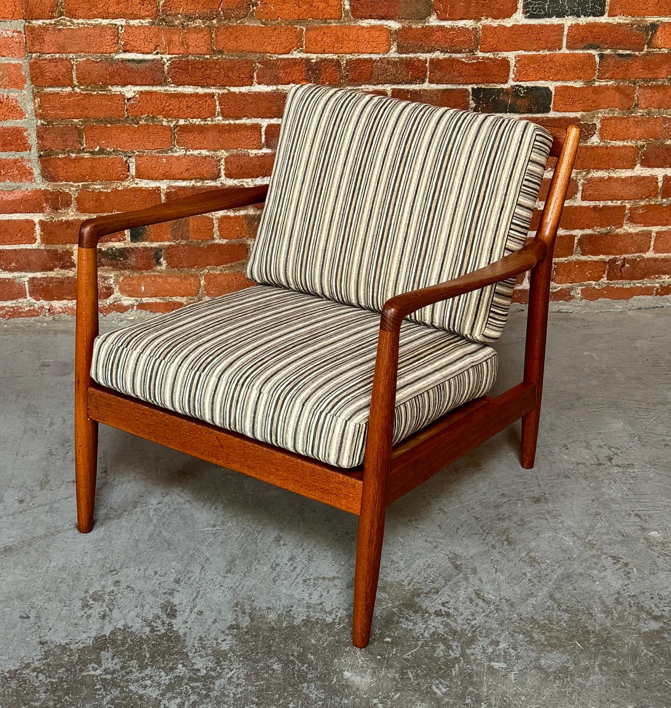 Dux of Sweden armchair in teak designed by Folke Ohlsson, the teak frame has smooth organic lines with a hand crafted look and feel. Newly refinished and treated with Tung oil to a silky finish to the touch. Reupholstered in a striped fabric with