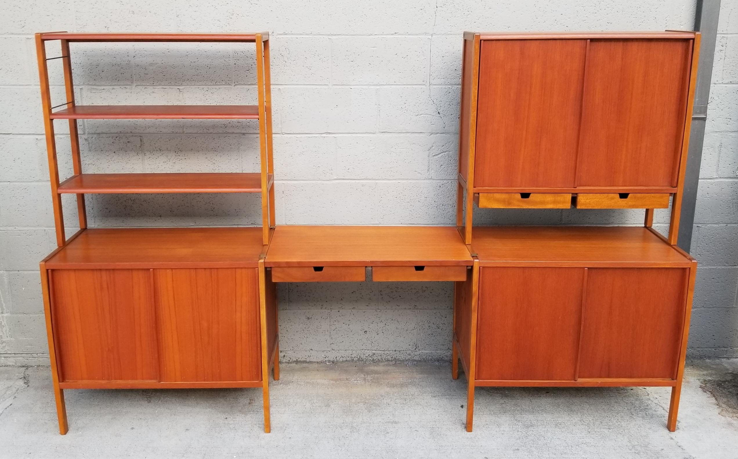 Exceptional Scandinavian Modern teak module wall unit by DUX Furniture, Sweden, circa 1950s-1960s. Beautiful glow to original finish. Consists of 5 units that can be easily moved and rearranged for specific needs. Two base cabinets, 2 uppers shelf