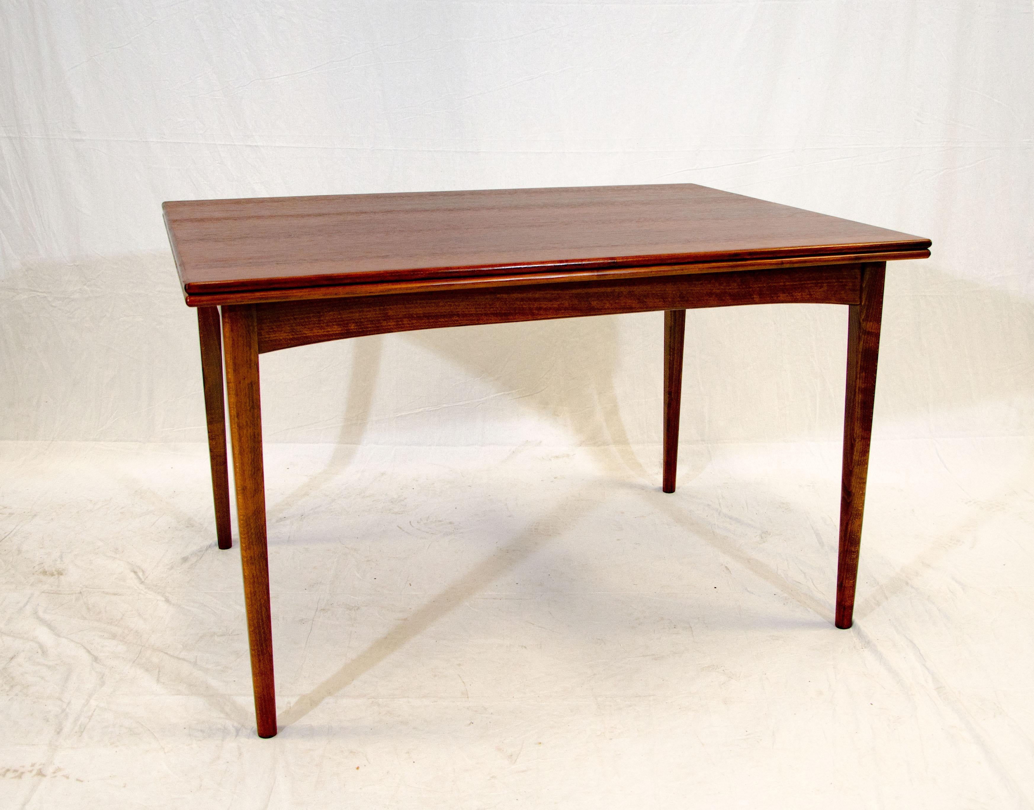 Unusual Dux walnut flip-top dining table from Sweden. The compact size is 47 1/4