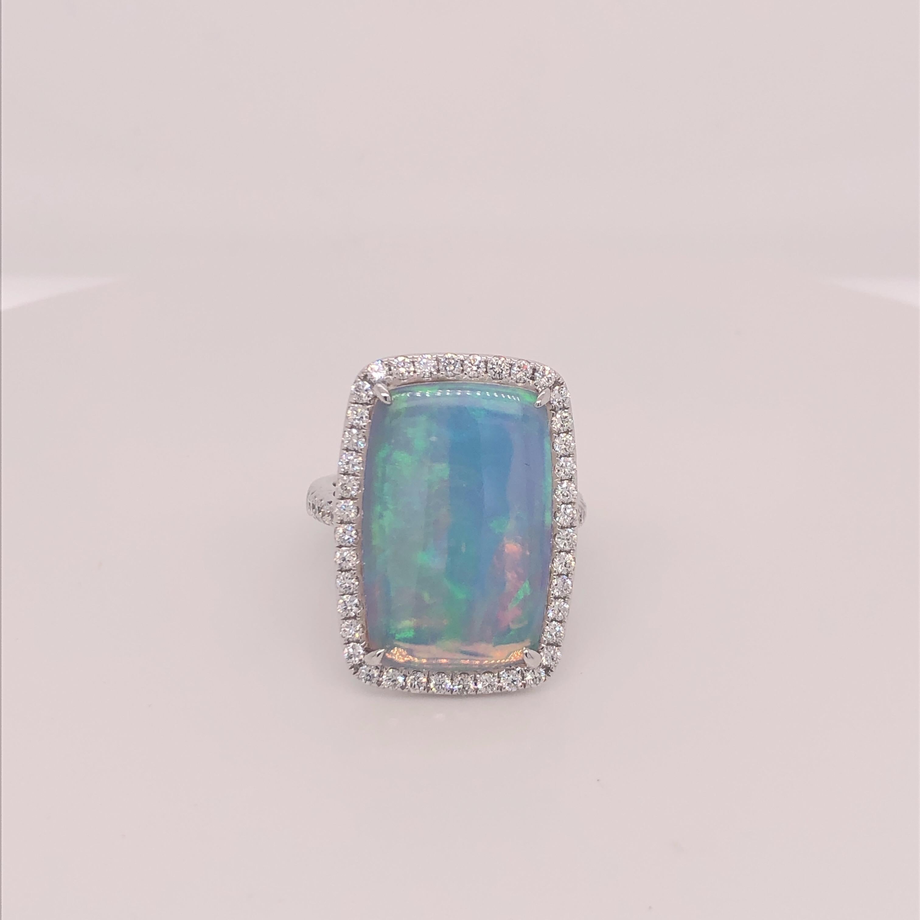 Dvani White Gold Opal and Diamond Ring.  Stamped 14K and Dvani.   This ring has a halo of pave diamonds and Diamonds half way around the shank.  A stunning piece! This ring is currently sized a 6 3/4 and can easily be sized.  Dvani is the Jeweler