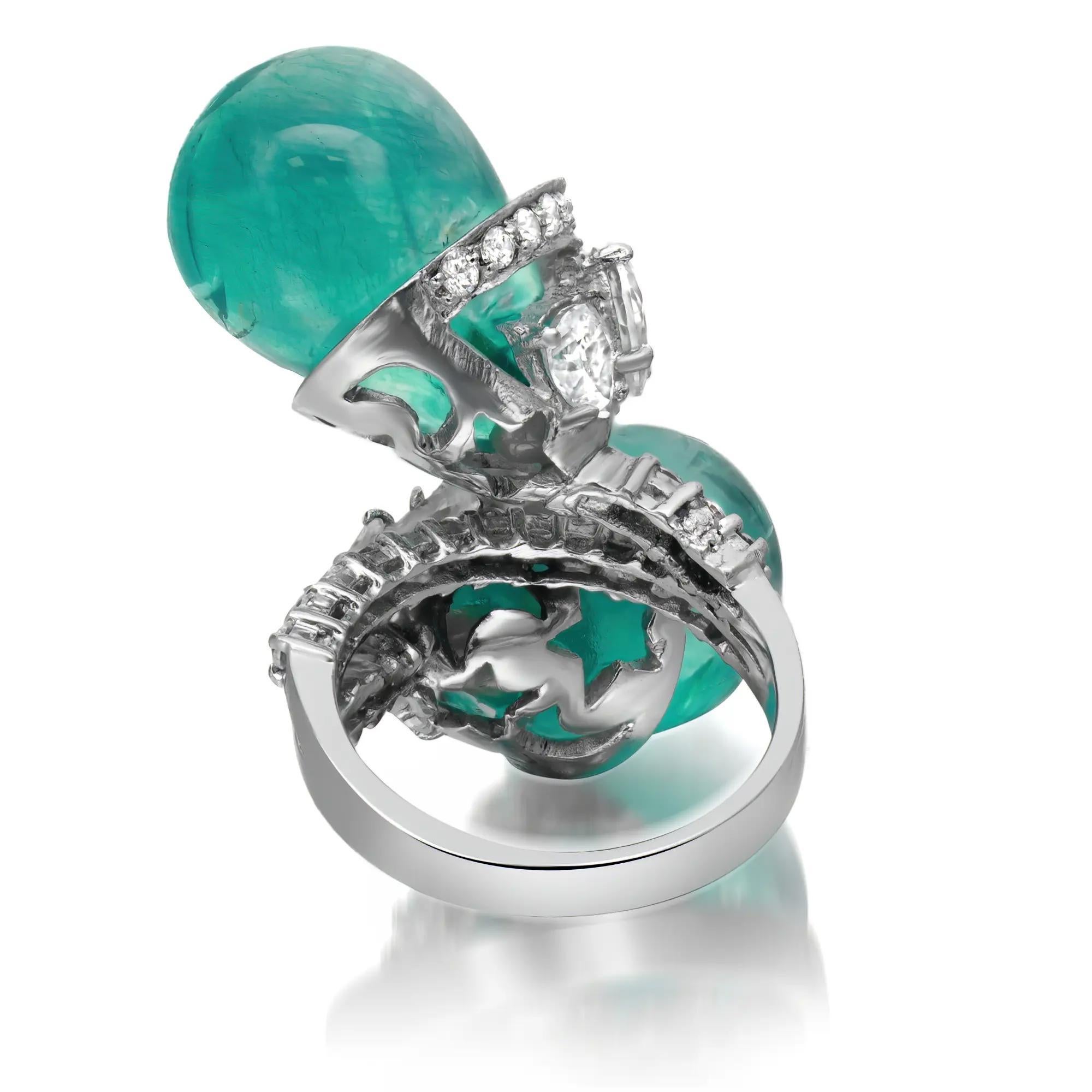 Bold and chunky crisscross cocktail ring. This ring features two green dyed quartz briolette stones encrusted in a 925 sterling silver crisscross mounting with dazzling pear and round cut cubic zirconia. A great pick for any occasion. Ring size