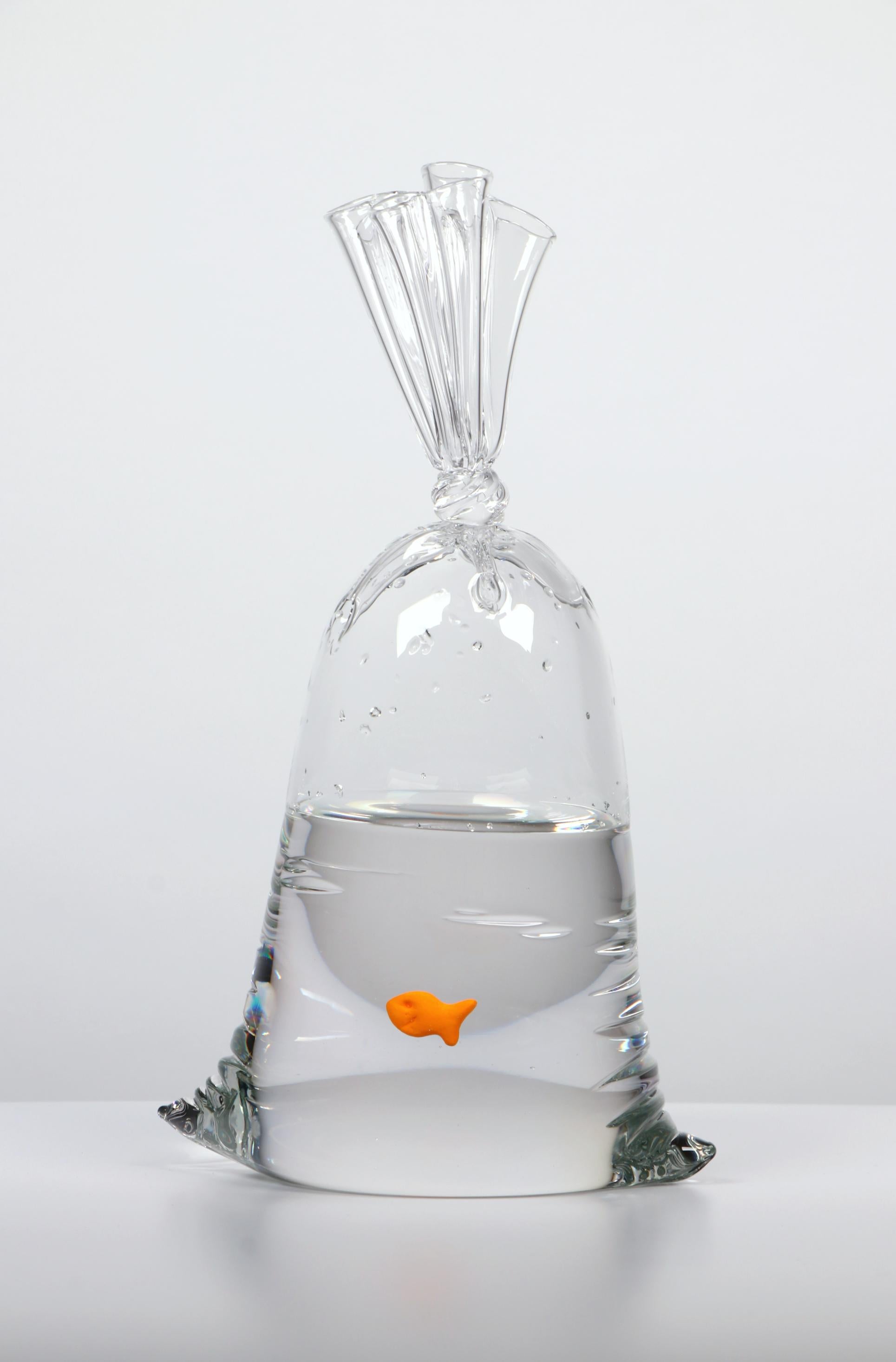 A hyper-realistic glass sculptor, Dylan's playful creations deceive the eye with their lifelike appearance. Whether mimicking water balloons or plastic bags filled with water housing a goldfish cracker, each piece is meticulously designed and