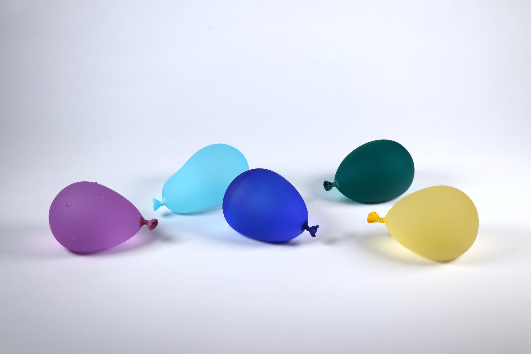 A hyper-realistic glass sculptor, Dylan's playful creations deceive the eye with their lifelike appearance. Whether mimicking water balloons or plastic bags filled with water housing a goldfish cracker, each piece is meticulously designed and