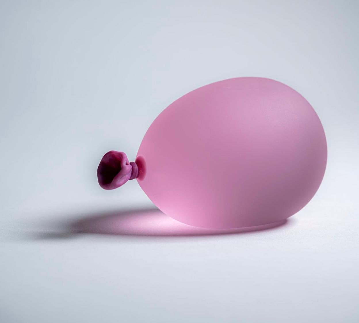 Pink hyperreal glass water balloon sculpture by Dylan Martinez. 

These hyperrealistic water balloons are made of solid sculpted glass sandblasted and acid-etched to resemble real water balloons. The sculptures are made in small batches, and each