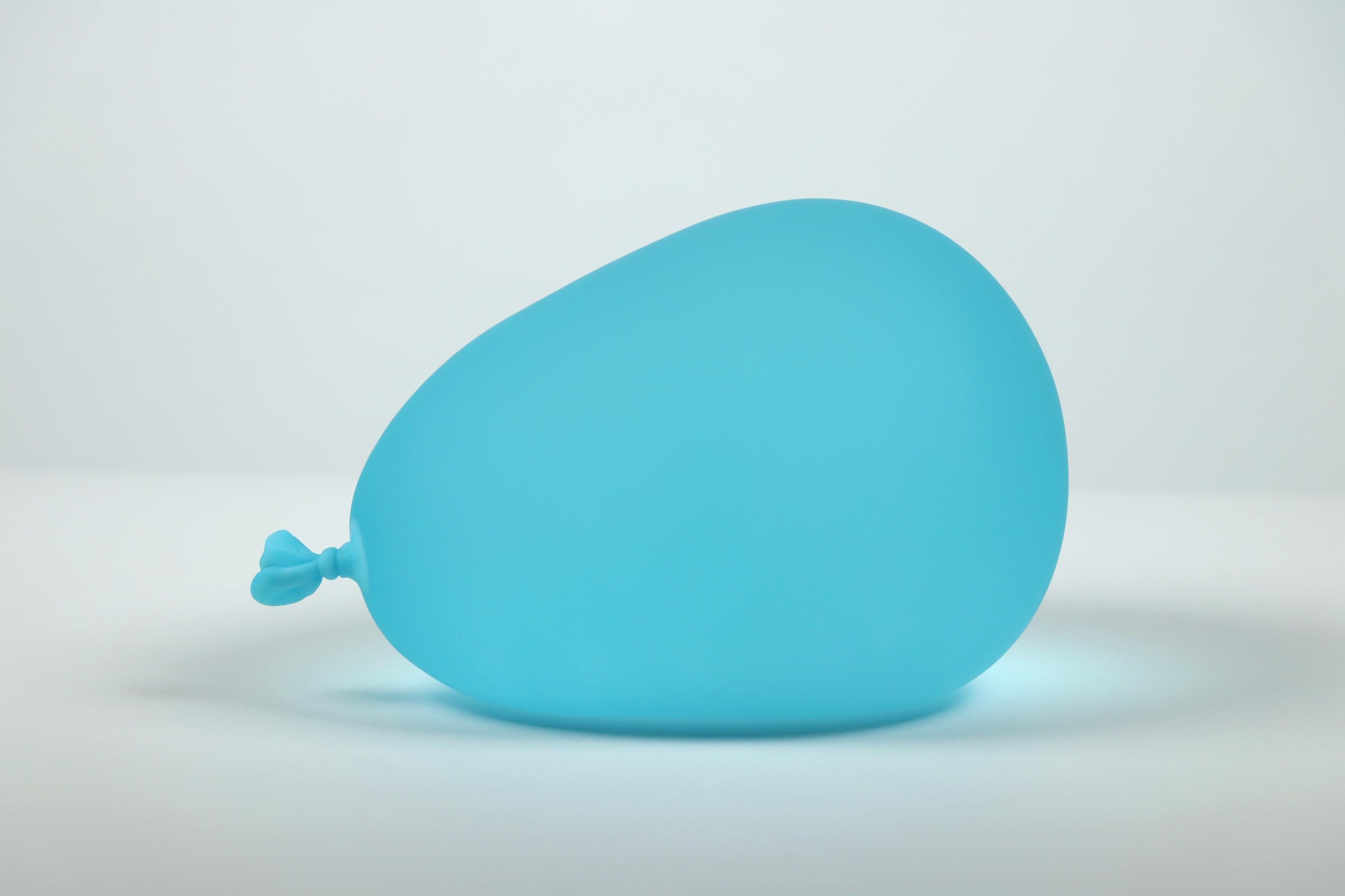 Pair of Small 
Large Hyperreal Blue Glass Water Balloon Sculptures by Dylan Martinez.  

Dylan Martinez’s hyperrealistic water balloons are made of solid sculpted glass sandblasted and acid-etched to resemble real water balloons. The sculptures